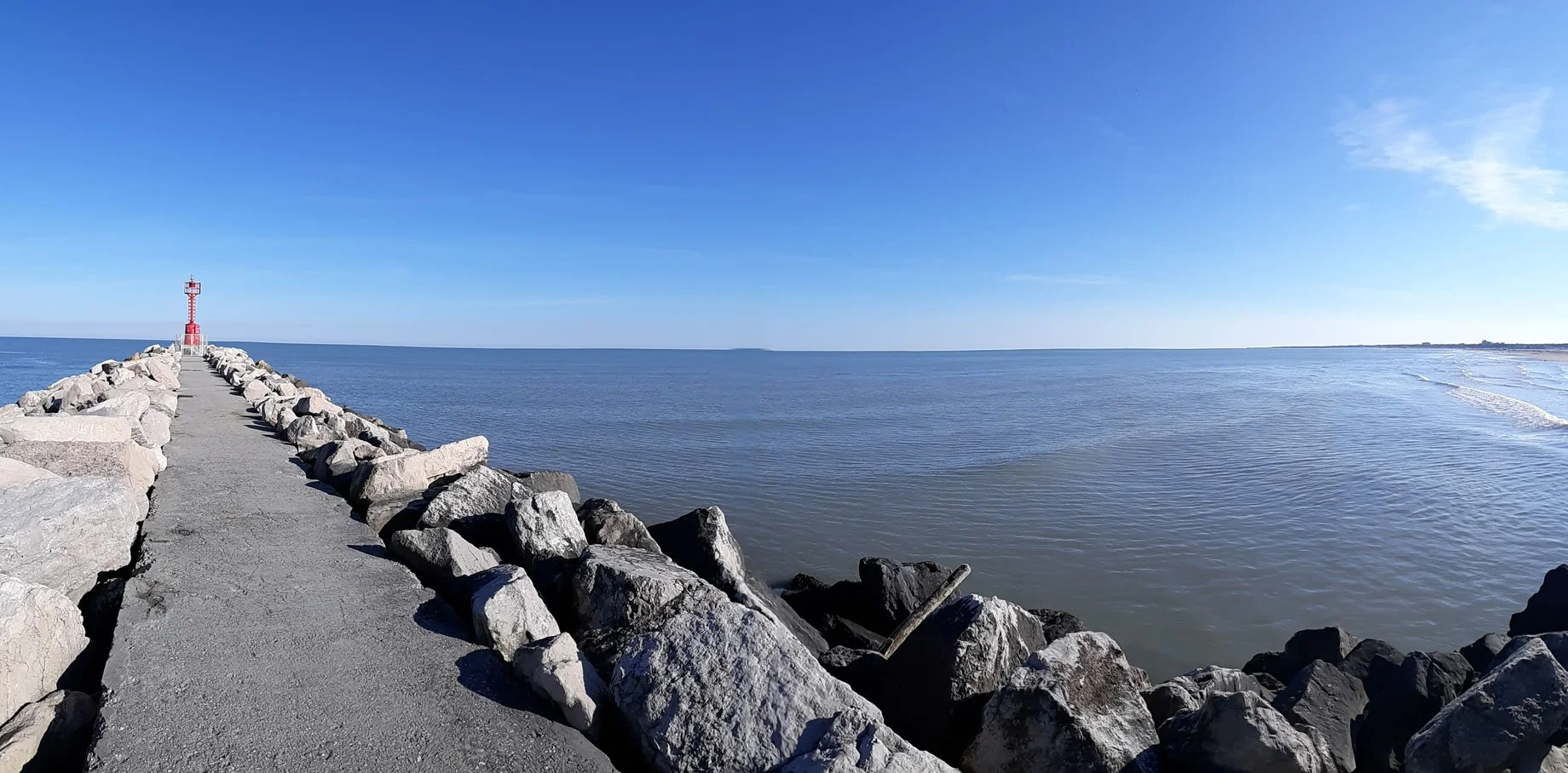 A concrete pier stretching out into the ocean, featuring Chef-crafted Mediterranean meals structured by the MFL dual-track nutritional system.