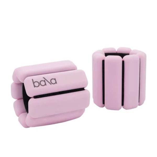 A pink, rounded, inflatable bracelet with the brand name "bala" on it, shown from both the side and top views.