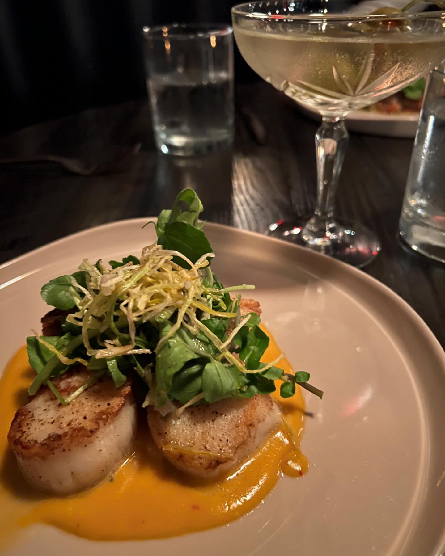 Our Seafood is Saintly. Try our perfectly Seared Diver Scallops with Nduja Beurre Blanc and a side of @titosvodka Martini at The Saint.