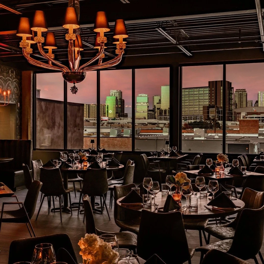 Sipping cocktails, indulging in Fresh Pasta and Texas Wagyu, with the best seat in the house &mdash; the glittering Dallas skyline sparkling right in front of you at @thesaintdallas ✨ From this second-story perch in the Design District, nearly every 