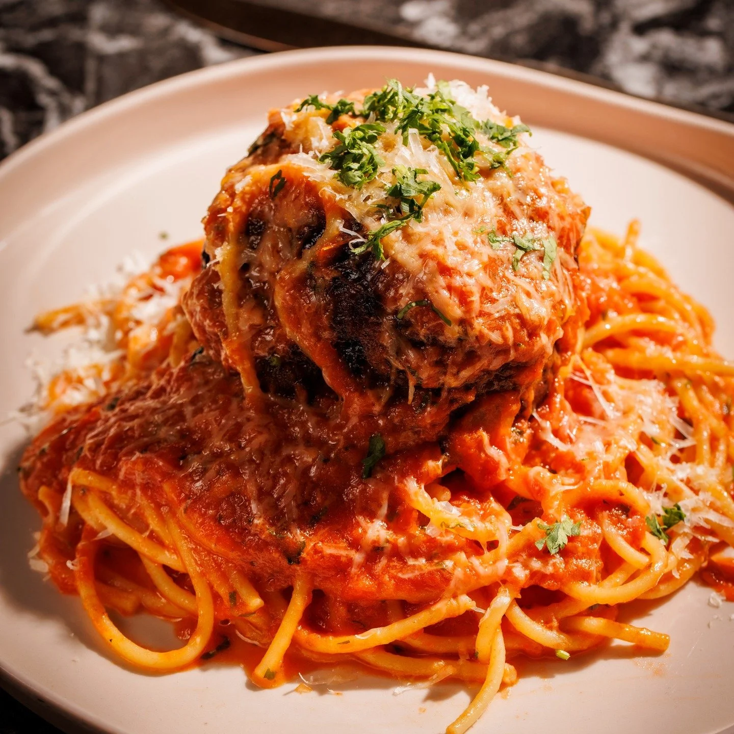 Everything's bigger in Texas &ndash; especially this epic 3/4 lb. Texas Wagyu Meatball atop house-made Spaghetti! Juicy, tender, and packed with flavor @thesaintdallas Pure indulgence on a plate.