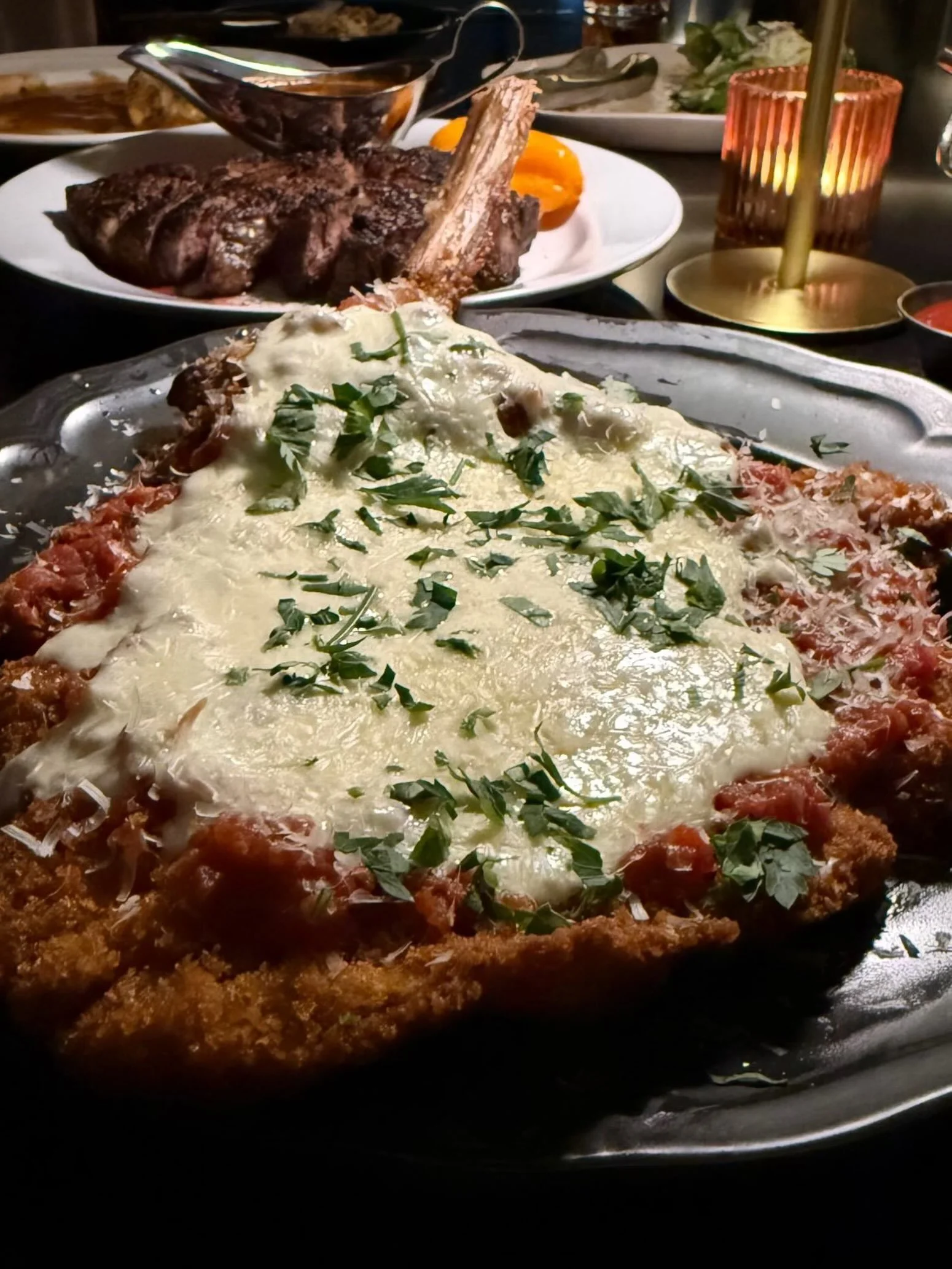 A heavenly experience on a plate at The Saint. Veal Parmigiano - Crispy, cheesy, and worth every single calorie. Consider this your sign to book that reservation in the Design District