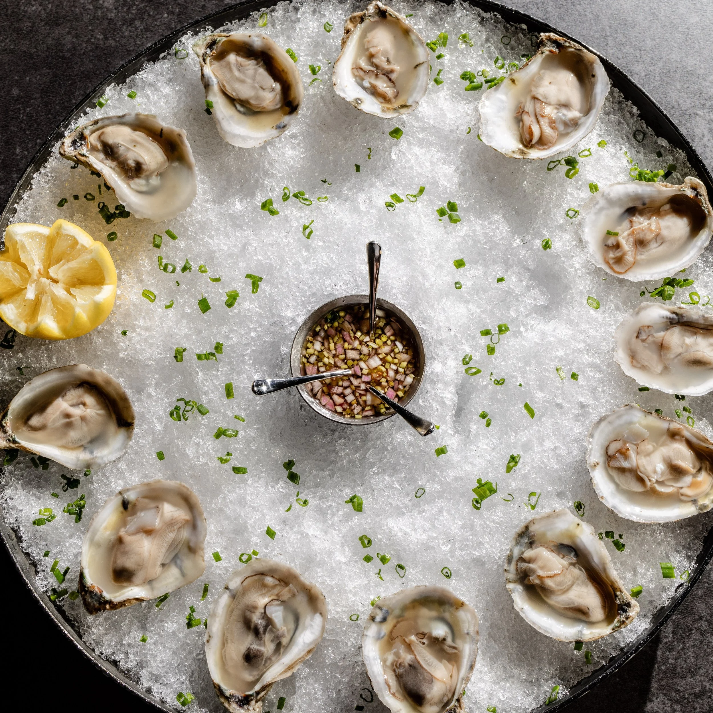 Fresh from the coast, these oysters arrive ice-cold and perfectly shucked, ready for a bright squeeze of lemon and a spoonful of our classic mignonette.
The perfect way to begin an evening at The Saint&mdash;whether you&rsquo;re settling in for Happy
