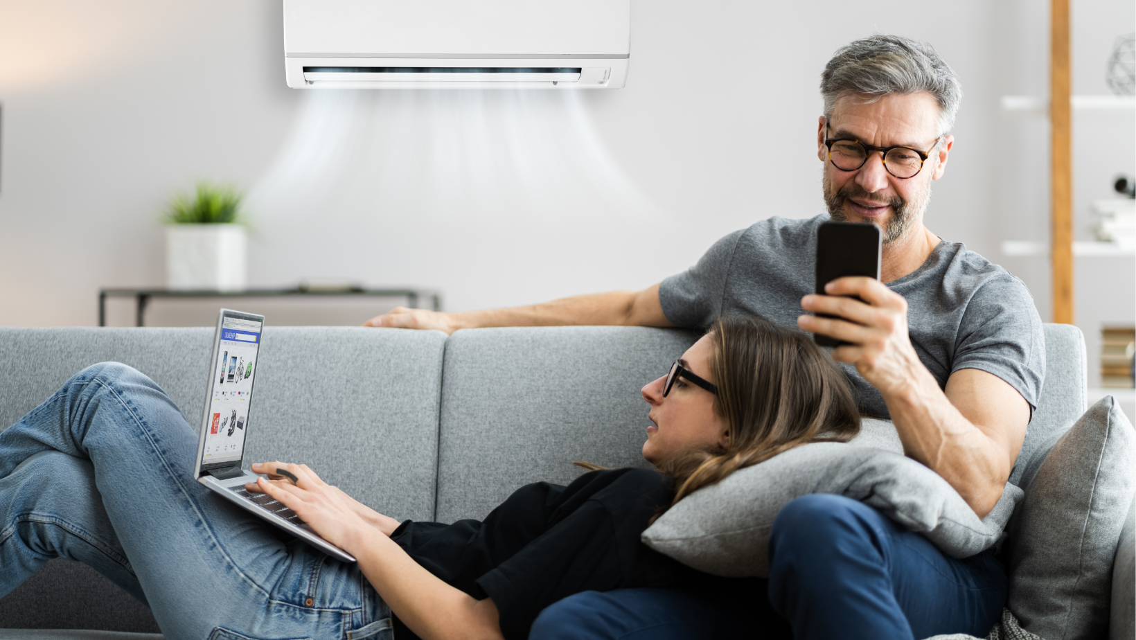 couple using remote wifi enabled ductless mini split HVAC system