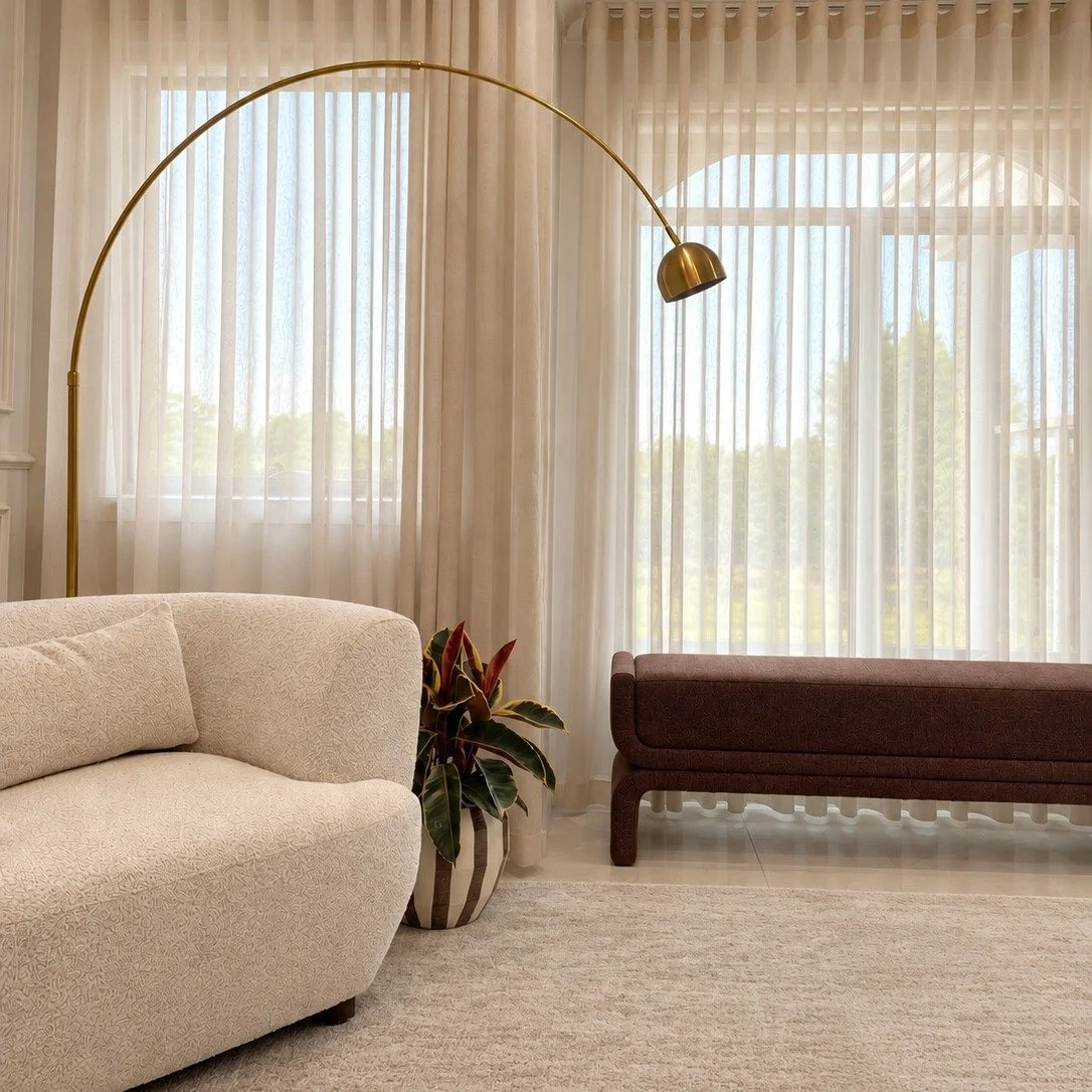 A little elegance, a lot of considered detail.

Soft curves, beautiful textures, statement lighting and classic wall panelling come together to create a living space that feels both refined and inviting.

We love the way the sculptural furniture soft