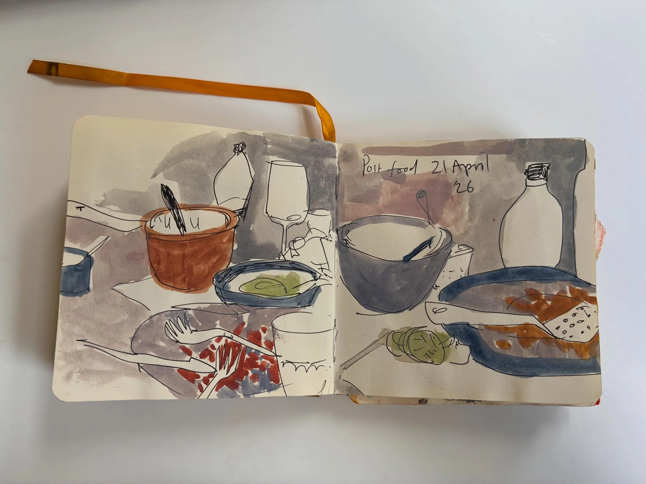 I do love flicking through sketchbooks and adding layers of colour/different materials weeks later. 
Line drawing of food detritus with guache added weeks later
Wash of colour, with cafe sketch followed by layer of yellow pastel over the drawing -not