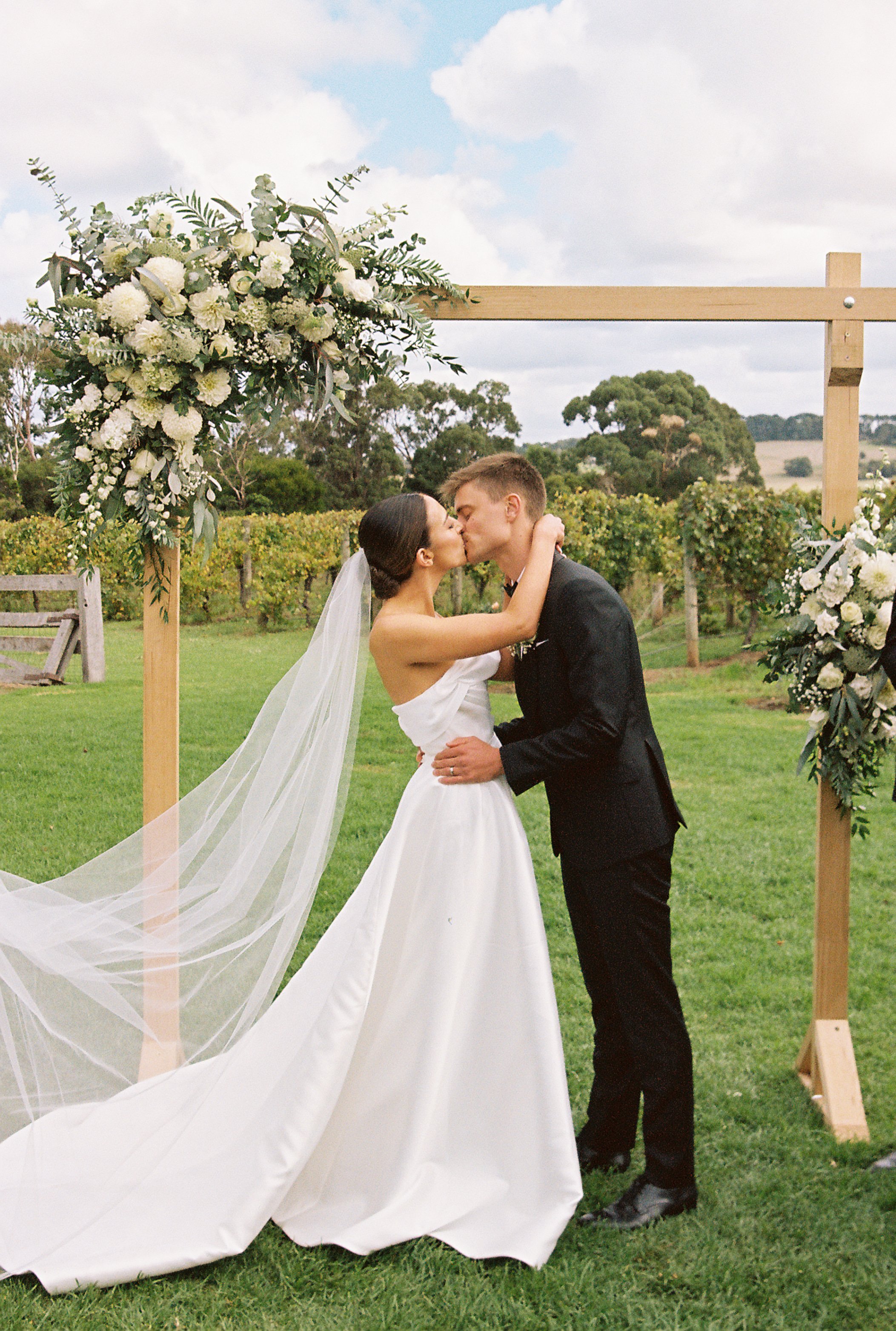 Romantic couple's portrait at a rustic wedding venue, captured on 35mm film