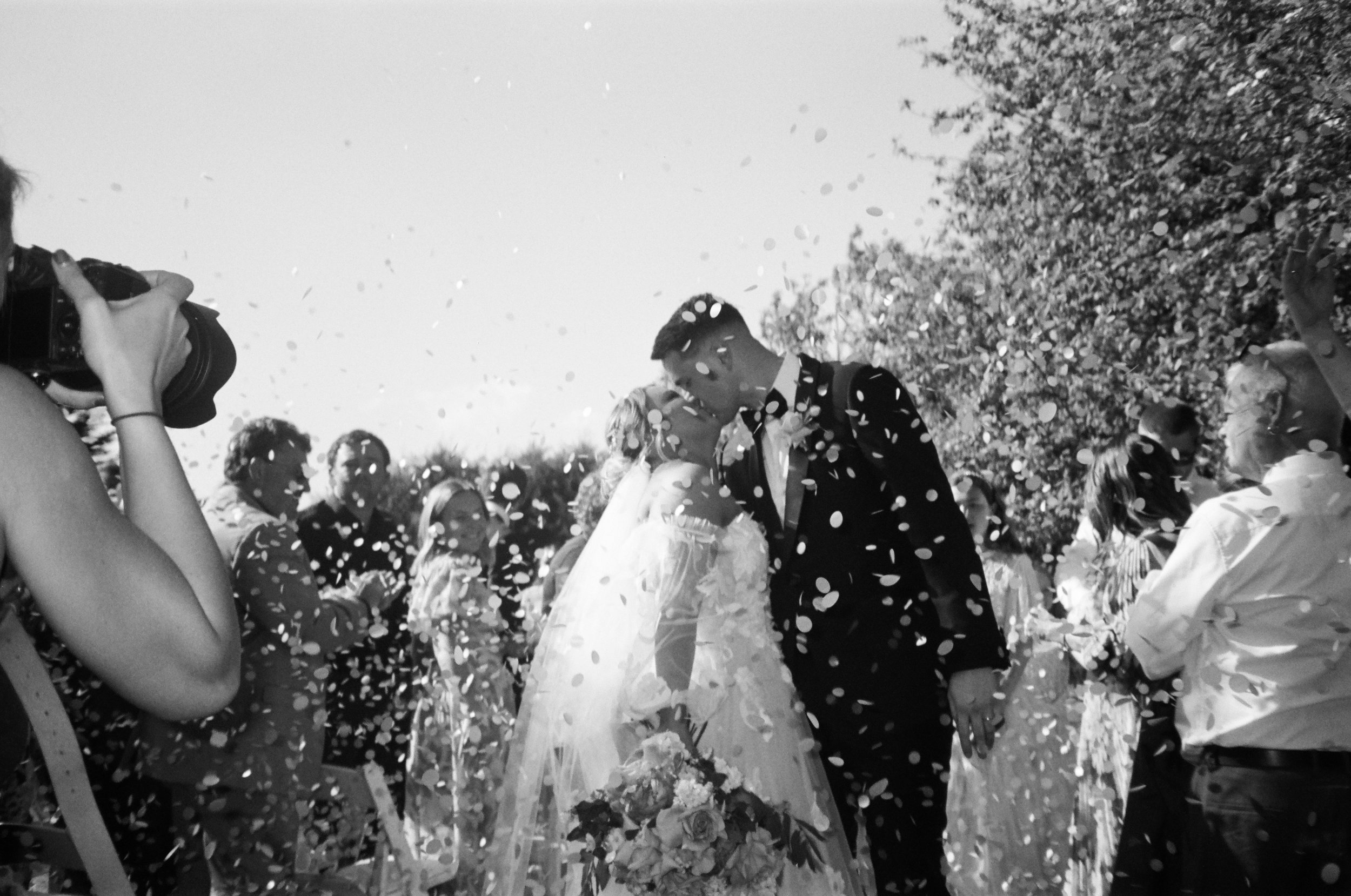 Joyful wedding reception photo on 35mm film black and white