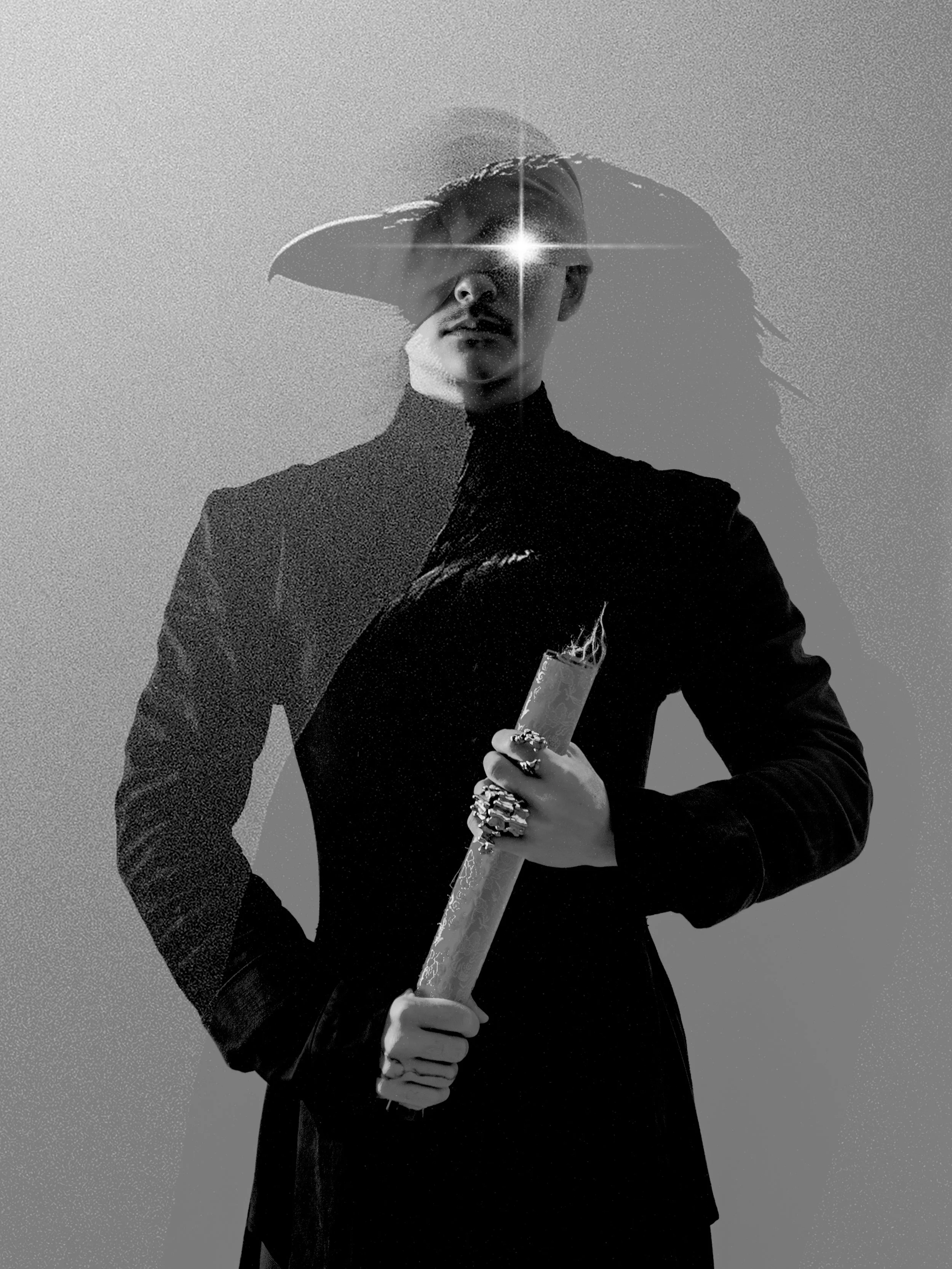 A person wearing a wide-brimmed hat, dark clothing, and multiple rings, holding a rolled-up paper or poster, with a star-shaped bright light in their eye in black and white.