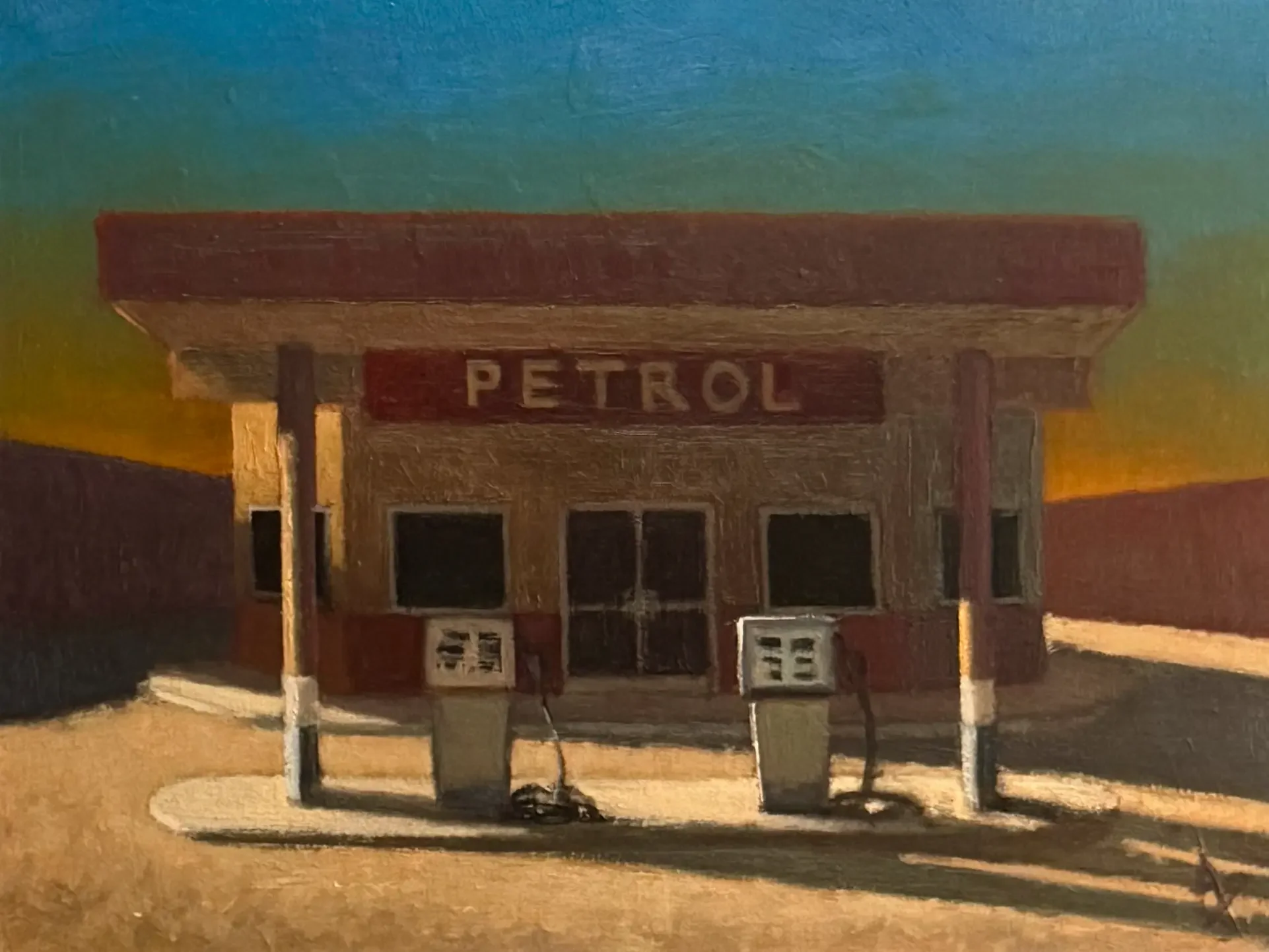 Petrol station at sunset with long shadows.  Golden hour makes the sky glow