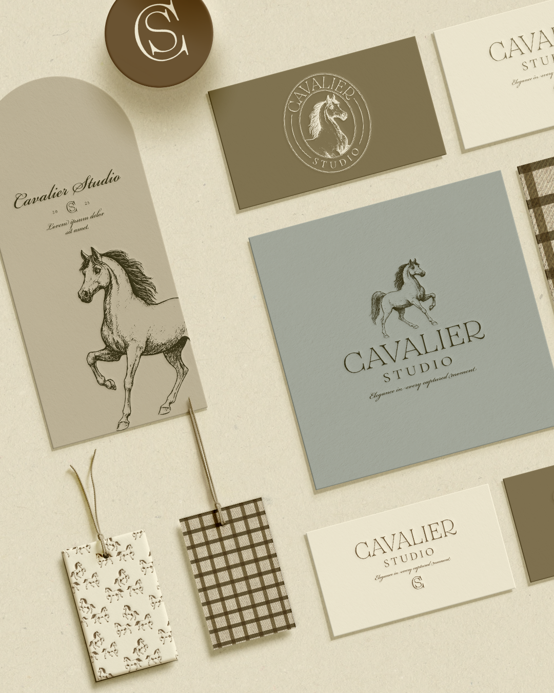 Various business cards and tags featuring horse illustrations and the 'Cavalier Studio' logo, laid out on a light surface.