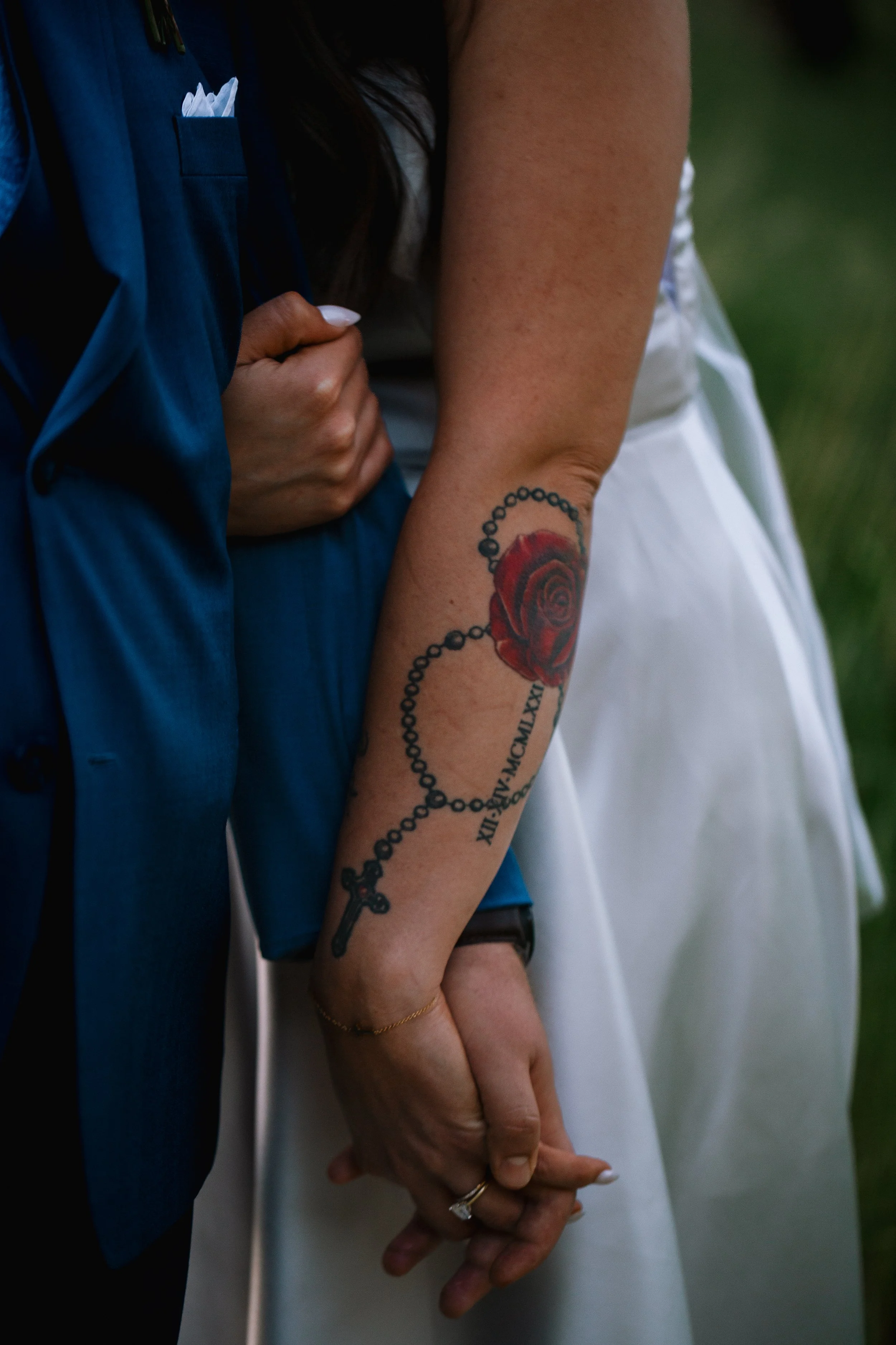 Bride and Groom's arms intertwined showing off their wedding rings on their wedding day
