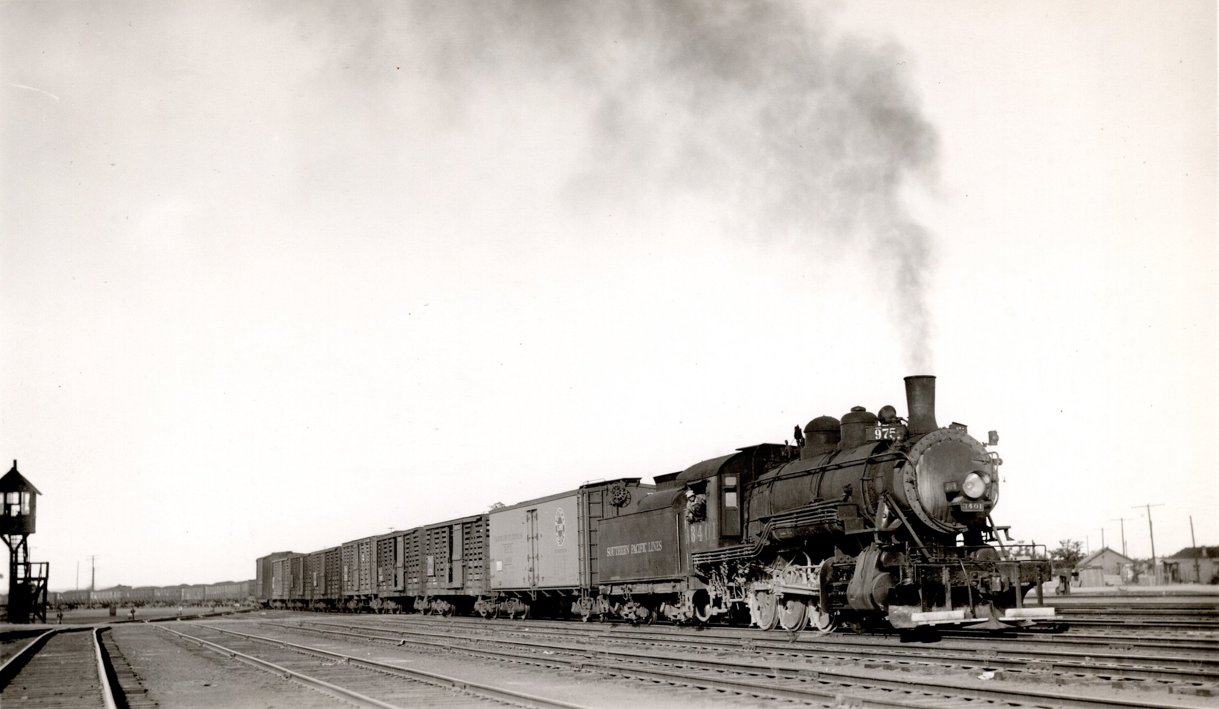 Southern Pacific 3401 with the train 975 entering the yard at Tucumcari, New Mexico.   SP 3401, a C-18 class 2-8-0, is returning from Dawson , New Mexico.  There are plenty of details to note in this photo.  The pilot plow behind the footboards is of