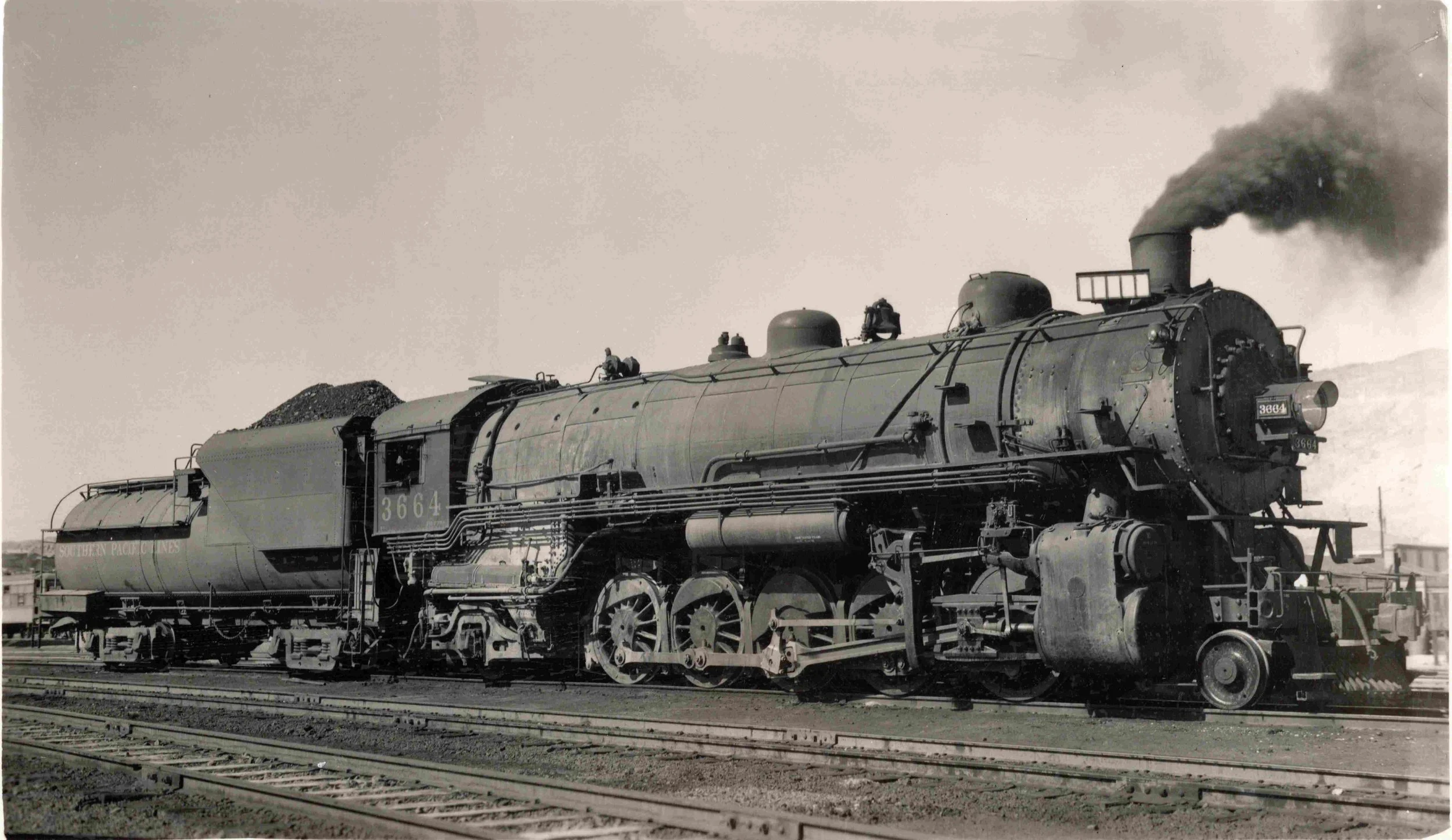This photographic image taken at El Paso shows the engineer’s side of Southern Pacific 2-10-2  F-3 class 3664.  The main rod  in the image is of interest.  I would like to know more about the design of the main rod.   Photographer unknown . Robby Pea