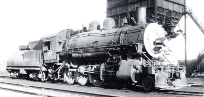 A view of the engineer's side of 3425 at the coaling tower at Tucumcari, New Mexico.  Note the locomotive is equipped with a power reverse, semi cylindrical tender, and the amount of sand on the second, third and fourth drivers.  Photographer unknown