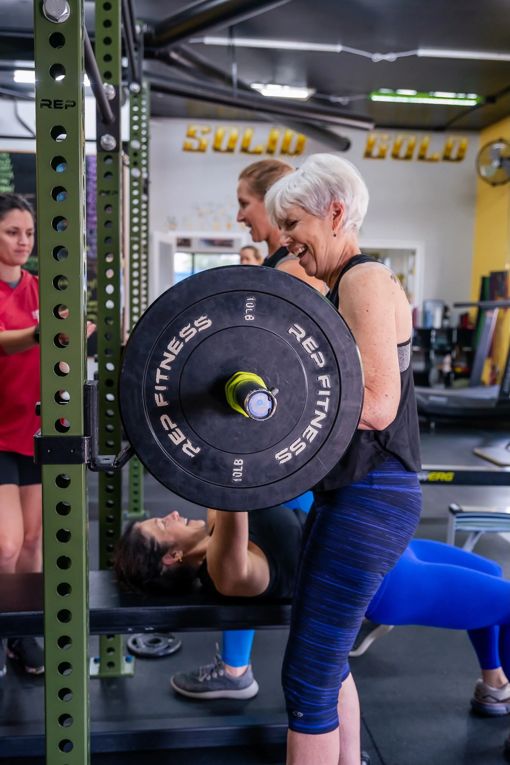 A member lifting with strength and confidence, representing the Empower membership