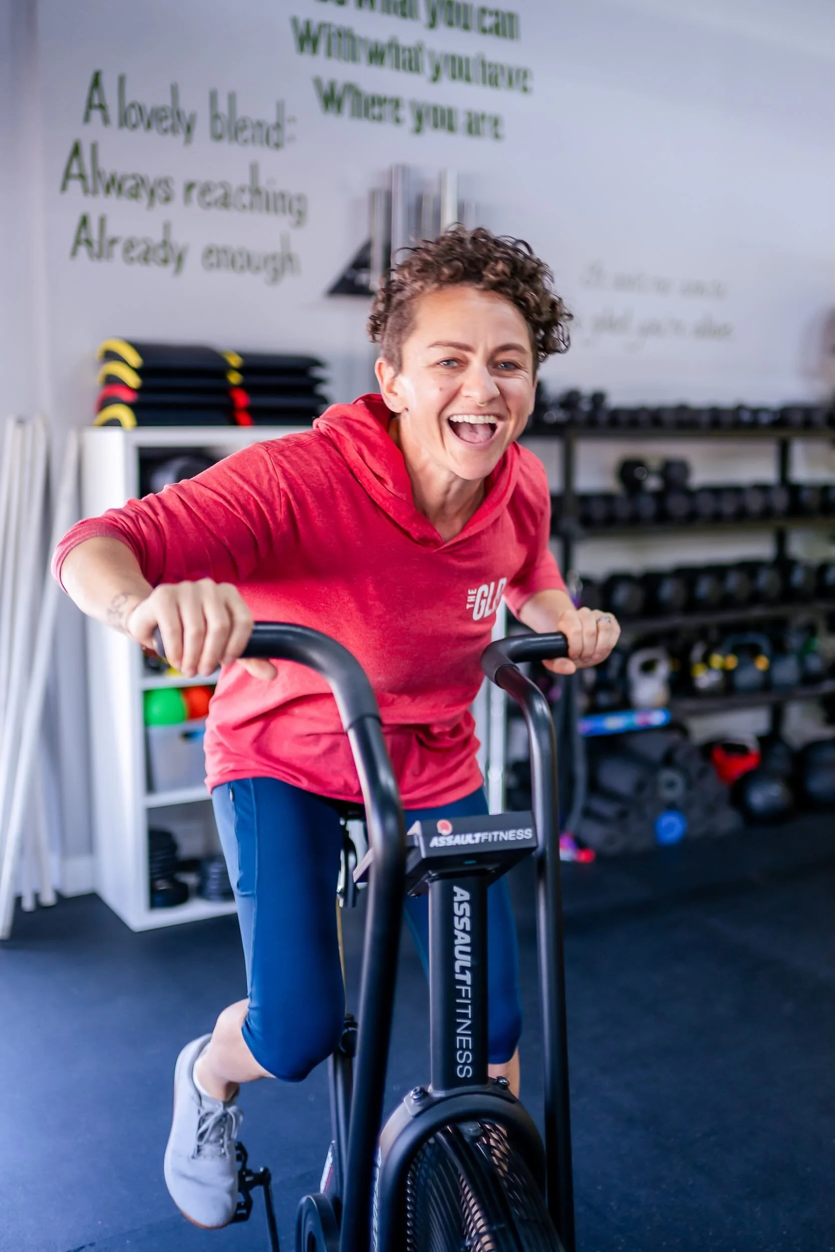 Coach Kari demonstrating form on the assault bike at The Golden Life Project