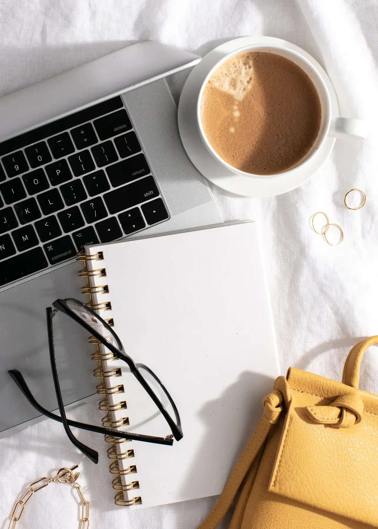 Keyboard, coffee and notepad representing working toward impossible goals.