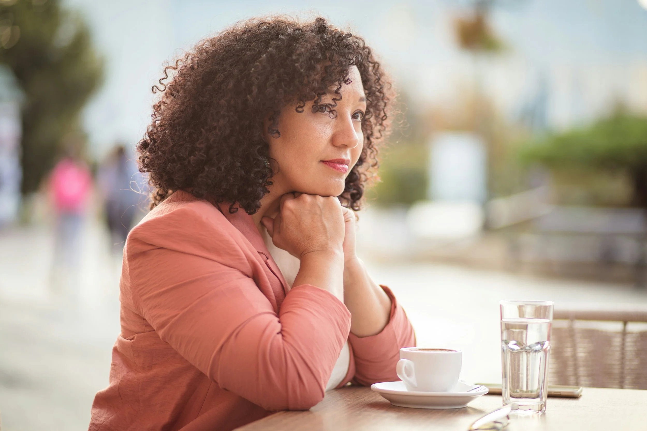 Person sitting calmly outdoors, illustrating slowing down to overcome overfunctioning