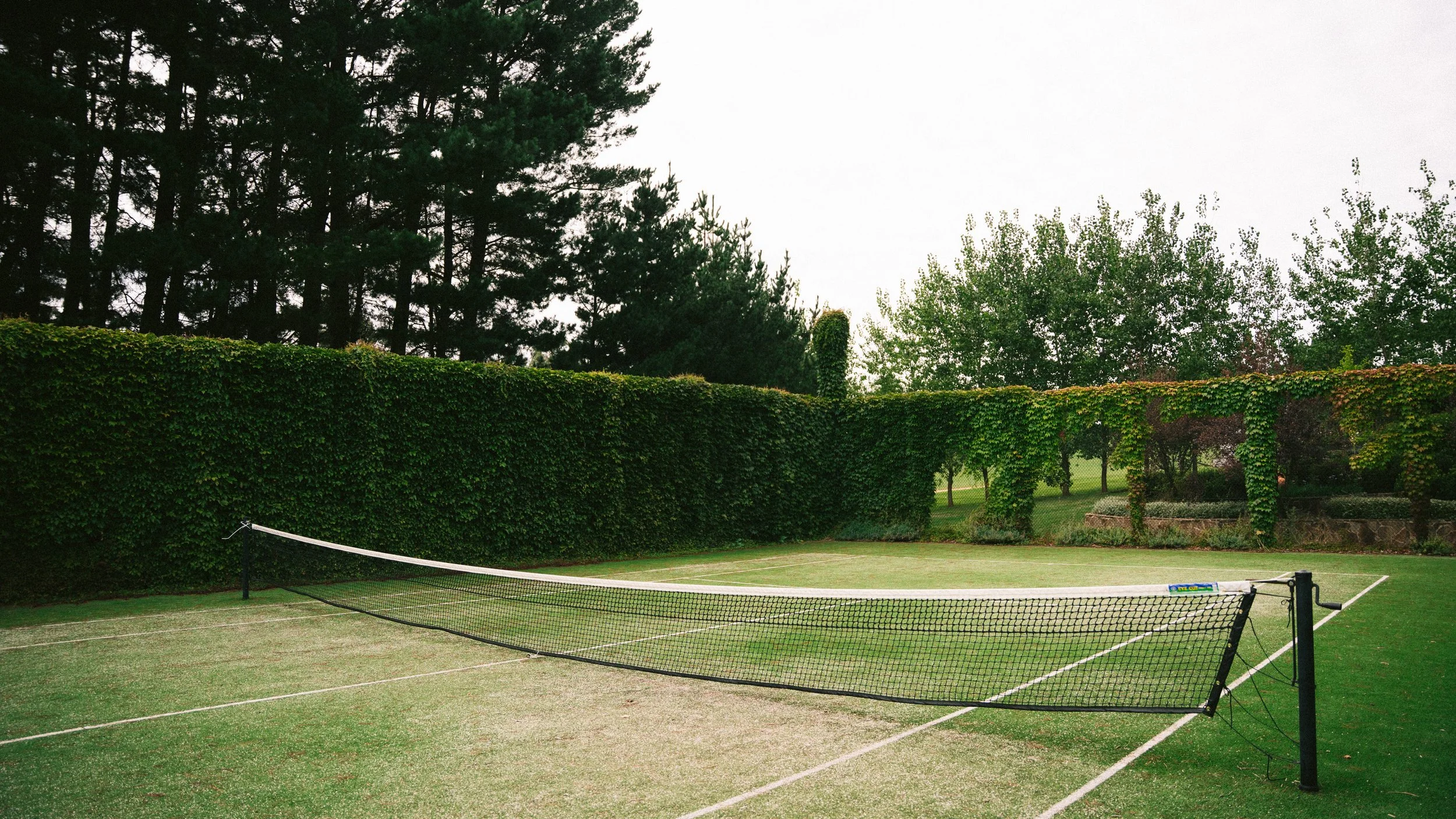 Private tennis court and hedged gardens at a luxury farm stay in NSW — Waldara Estate, Edith NSW, near Sydney and the Blue Mountains