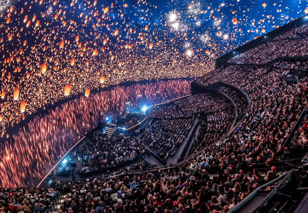 Drone shot of Zac Brown Band's Sphere residency, showing a crowd of people looking at content of floating lanterns on the media plane