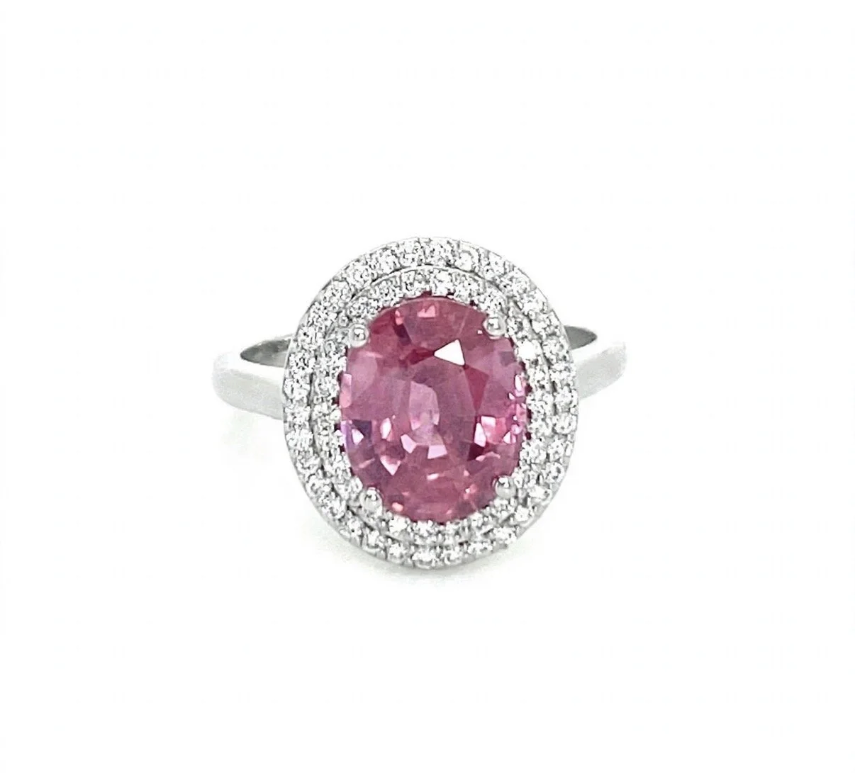 Ring with pink sapphire surrounded by a halo of small white diamonds.