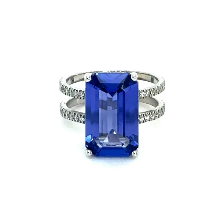 White gold ring with dual bands encrusted with small diamonds, featuring a large rectangular tanzanite gemstone set in the center.