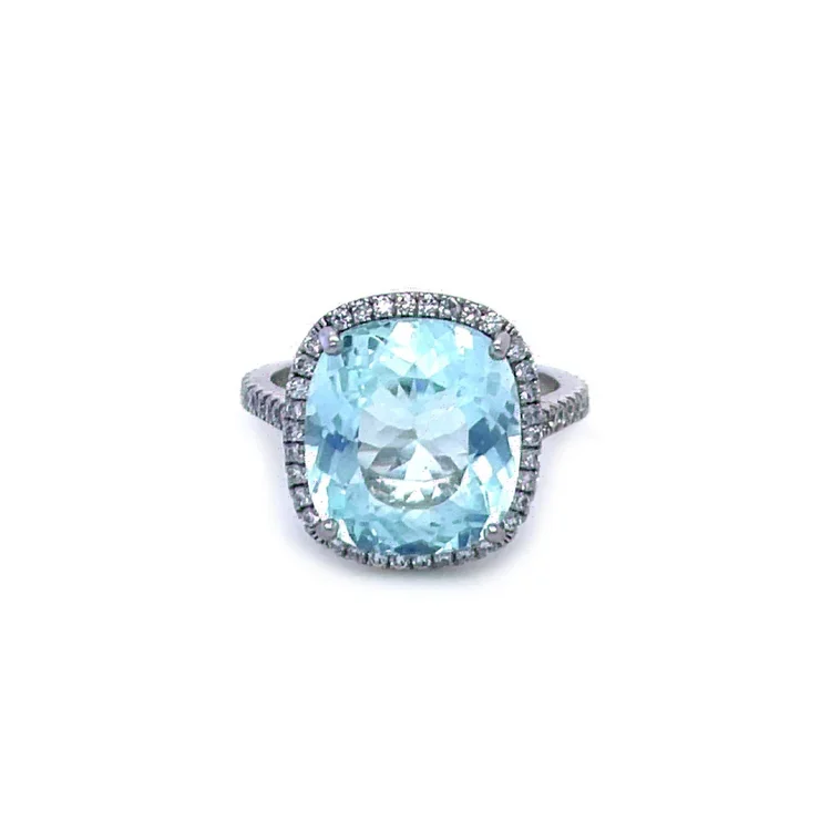 Parabia tourmaline surrounded by small diamonds on a white gold band.