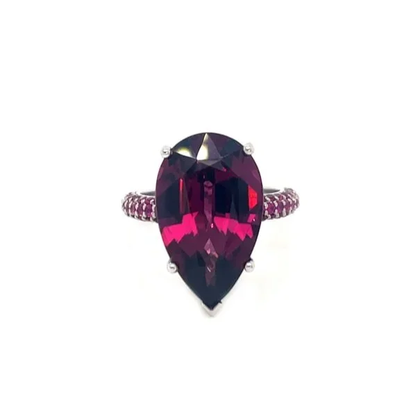 Ring with a large teardrop-shaped pink garnet gemstone and a pink sapphire gemstone band.