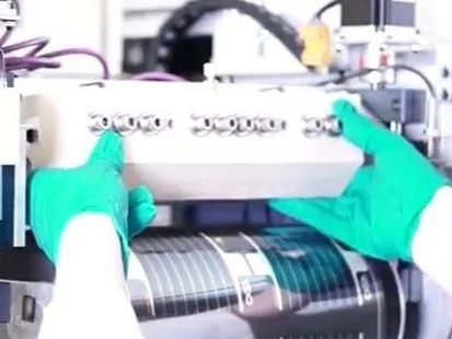 Hands operating a machine.