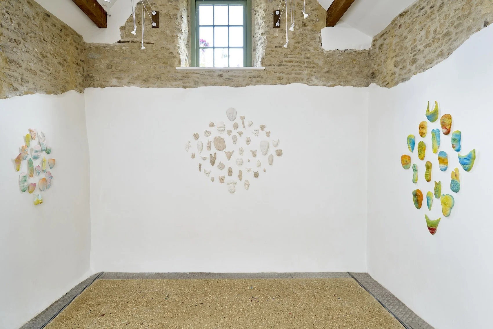 Left: Apparition, 2024. Glazed ceramic, 16 elements wall based 75 x 58 x 5cm. Centre: Gathering, 2024. Glazed ceramic & porcelain. 130 x 118 x 6 cm. Right: Spectral Constellation, 2024. Glazed ceramic. 125 x 95 x 6 cm. 
