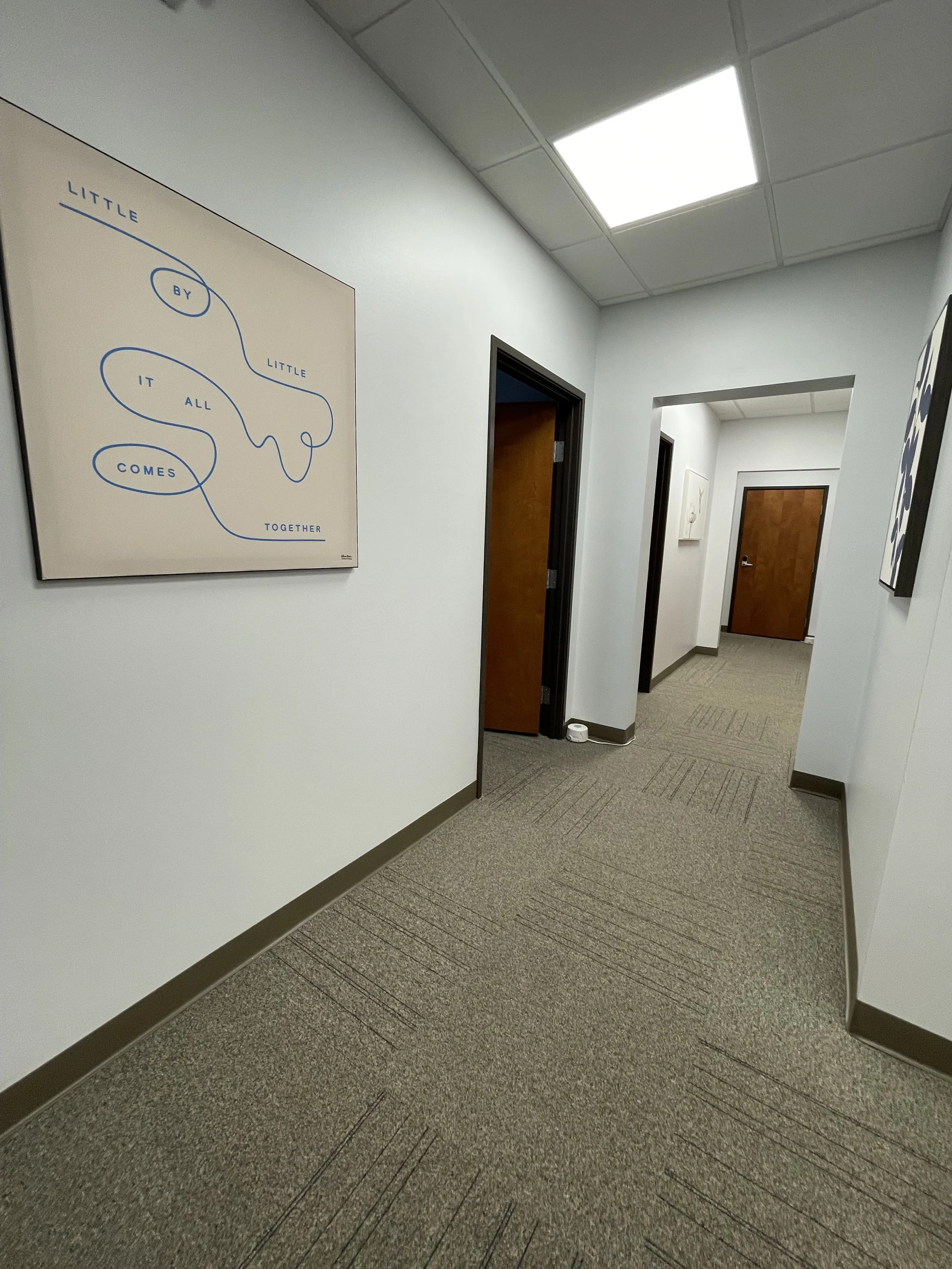 Hallway with encouraging picture. Indianapolis, IN counseling private practice. Therapist near me specialized in providing trauma therapy, anxiety therapy and couples counseling.