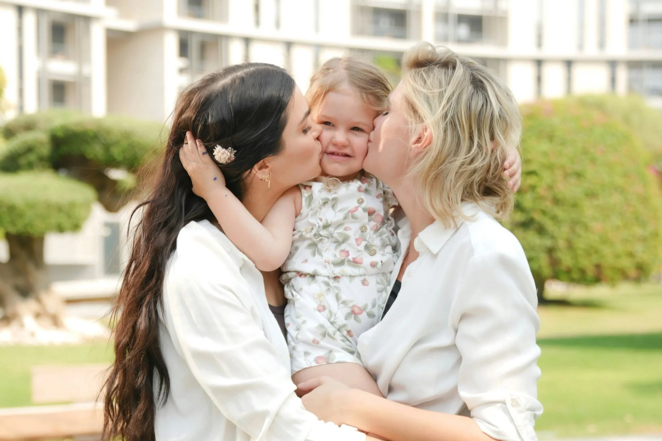 Photo of a LBGTQ couple with their daughter. Are you and your partner looking for ways you can connect more deeply? Discover how LGBTQ couples therapy in Indianapolis, IN can help you deepen your connection even more.