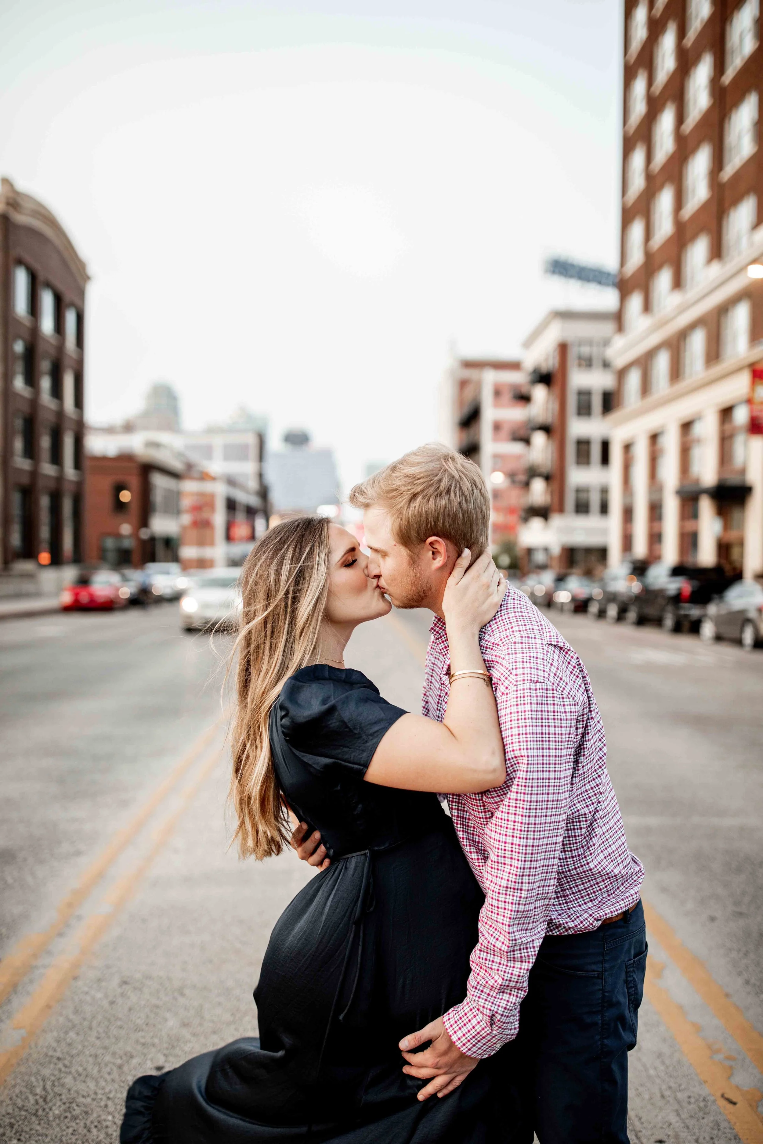Couple kissing in the street in Downtown Kansas City