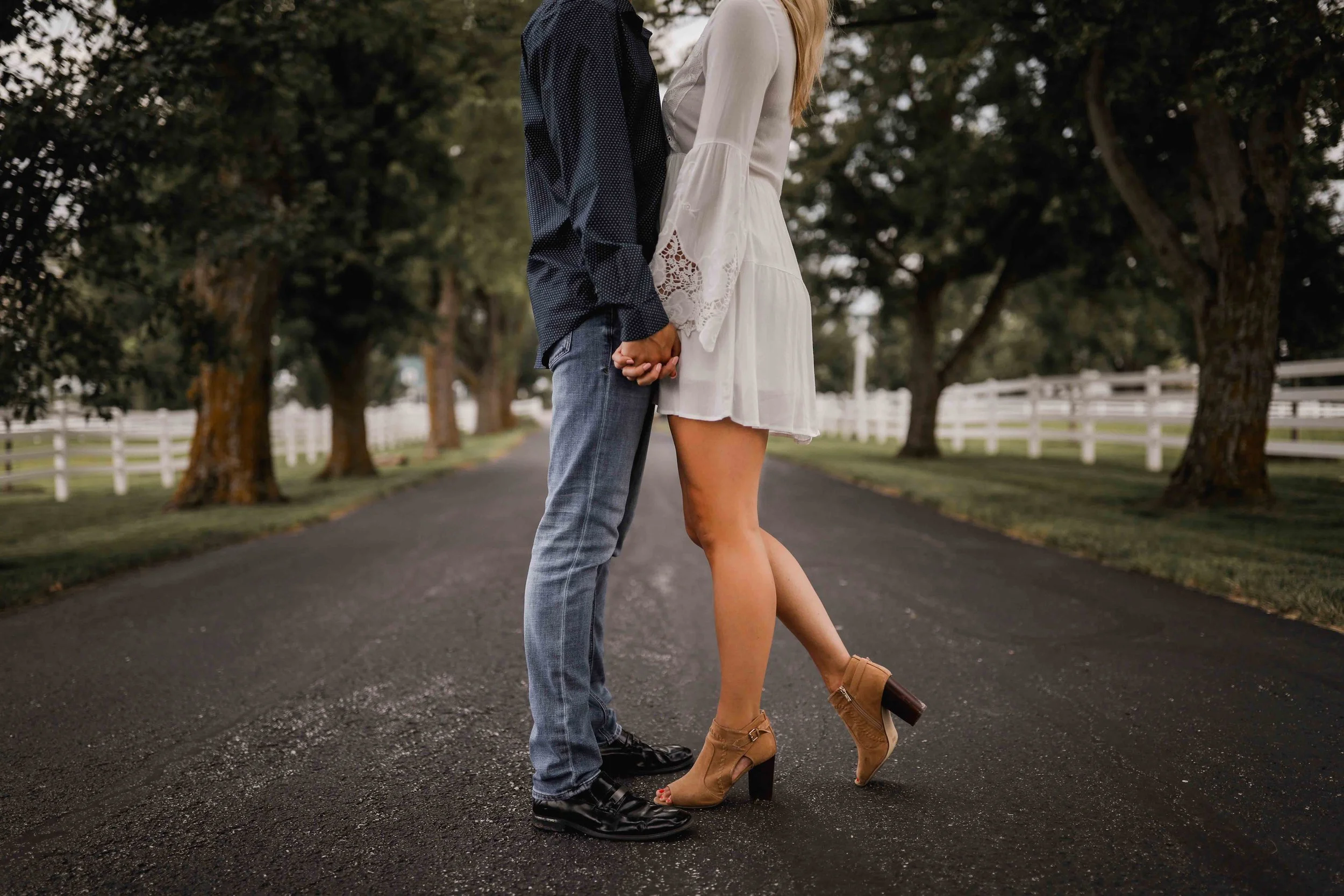 Man and woman standing on the street holding hands at Lone Summit Ranch in Lee's Summit Missouri