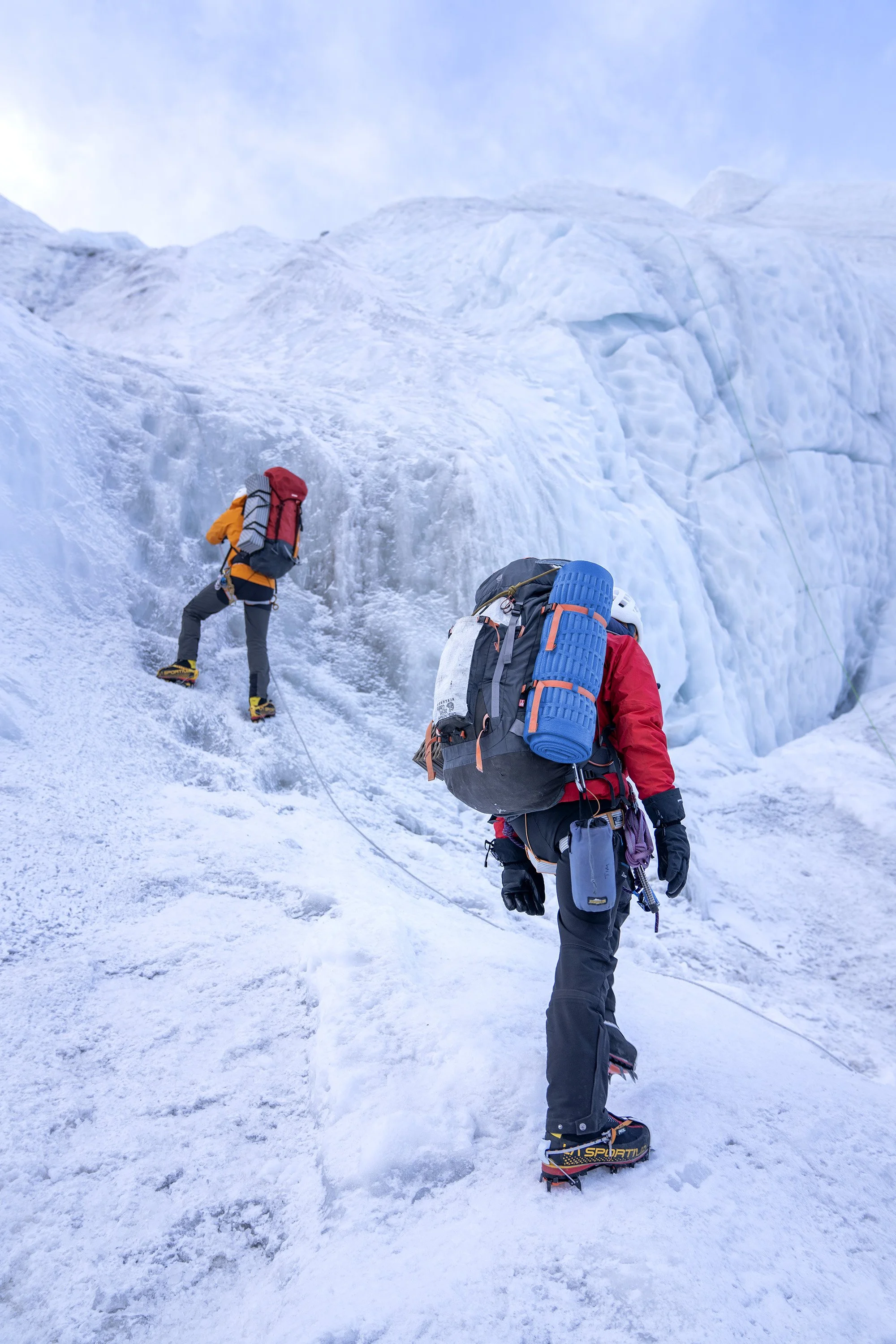 Two climbers ascend the Khumbu Icefall on Mount Everest. dynamic sports portrait photography by Steve Bright