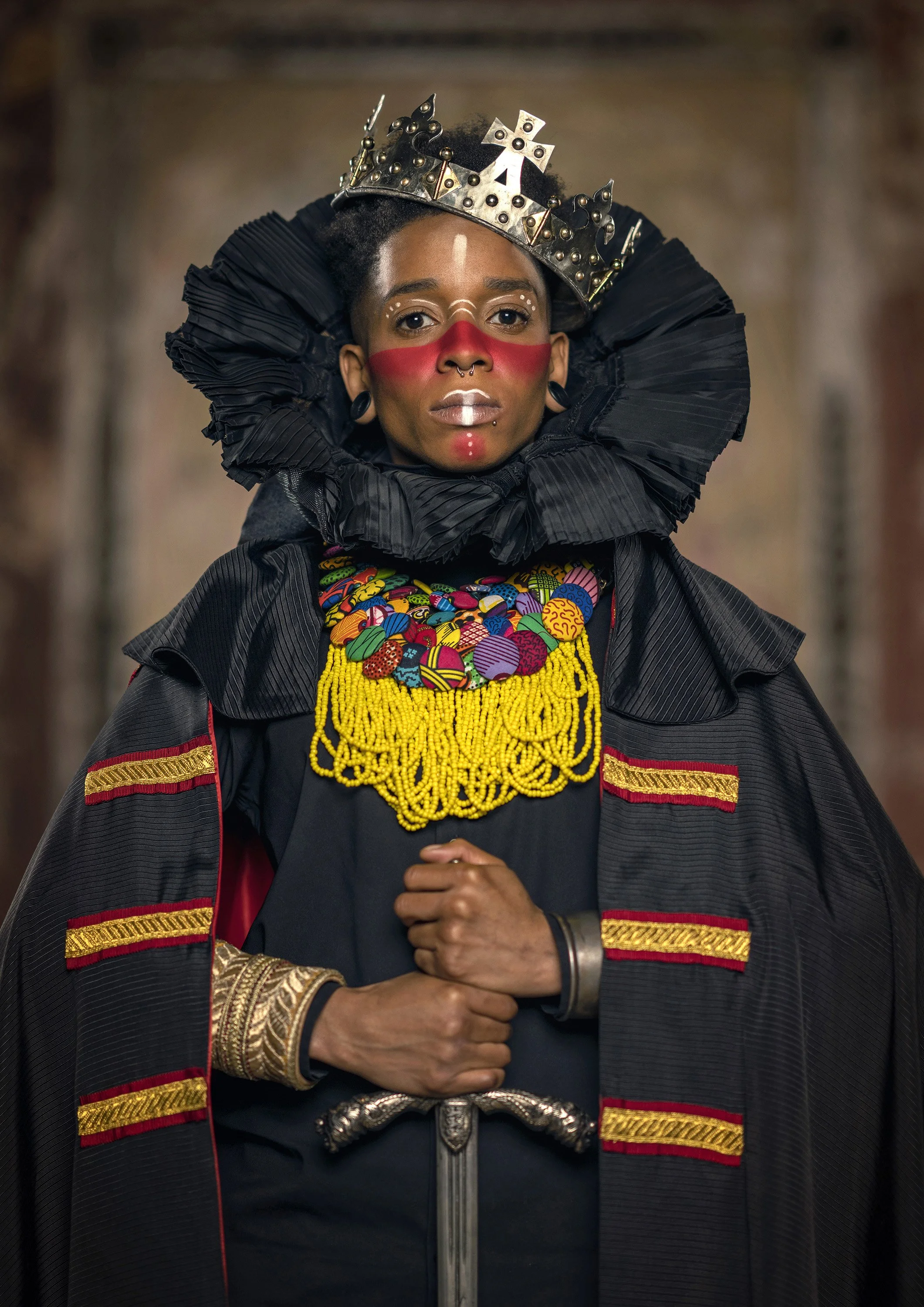 A young Black woman with red facepaint poses in a modern reimagining of a regal outfit, in a modern Afrofuturist version of a royal portrait. commercial portrait photography by Steve Bright