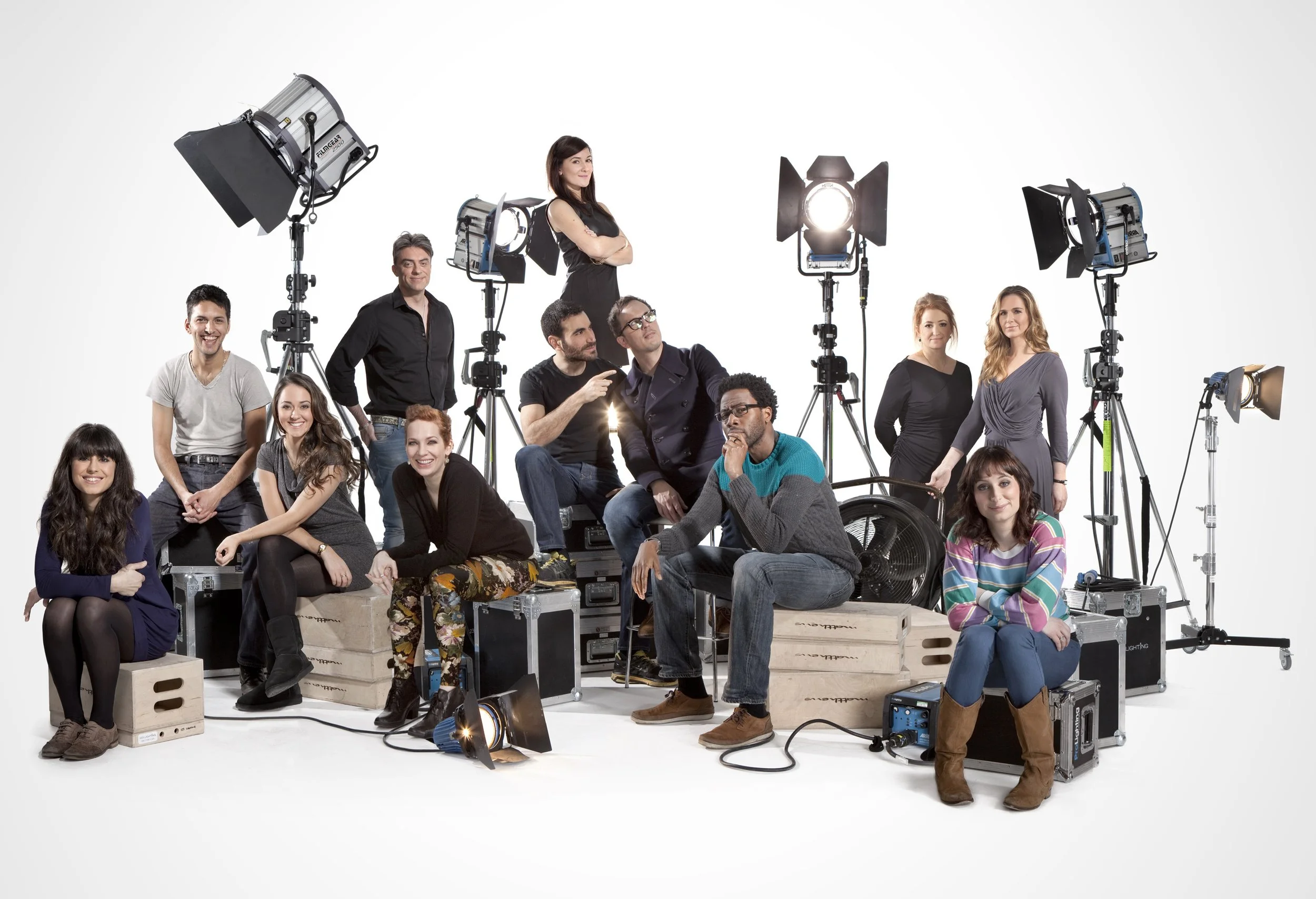 promo image for a season of love stories at Sky TV. Various writers and performers from the shows sit on apple boxes and flight cases, surrounded by film lights. entertainment portrait photography by Steve Bright, London