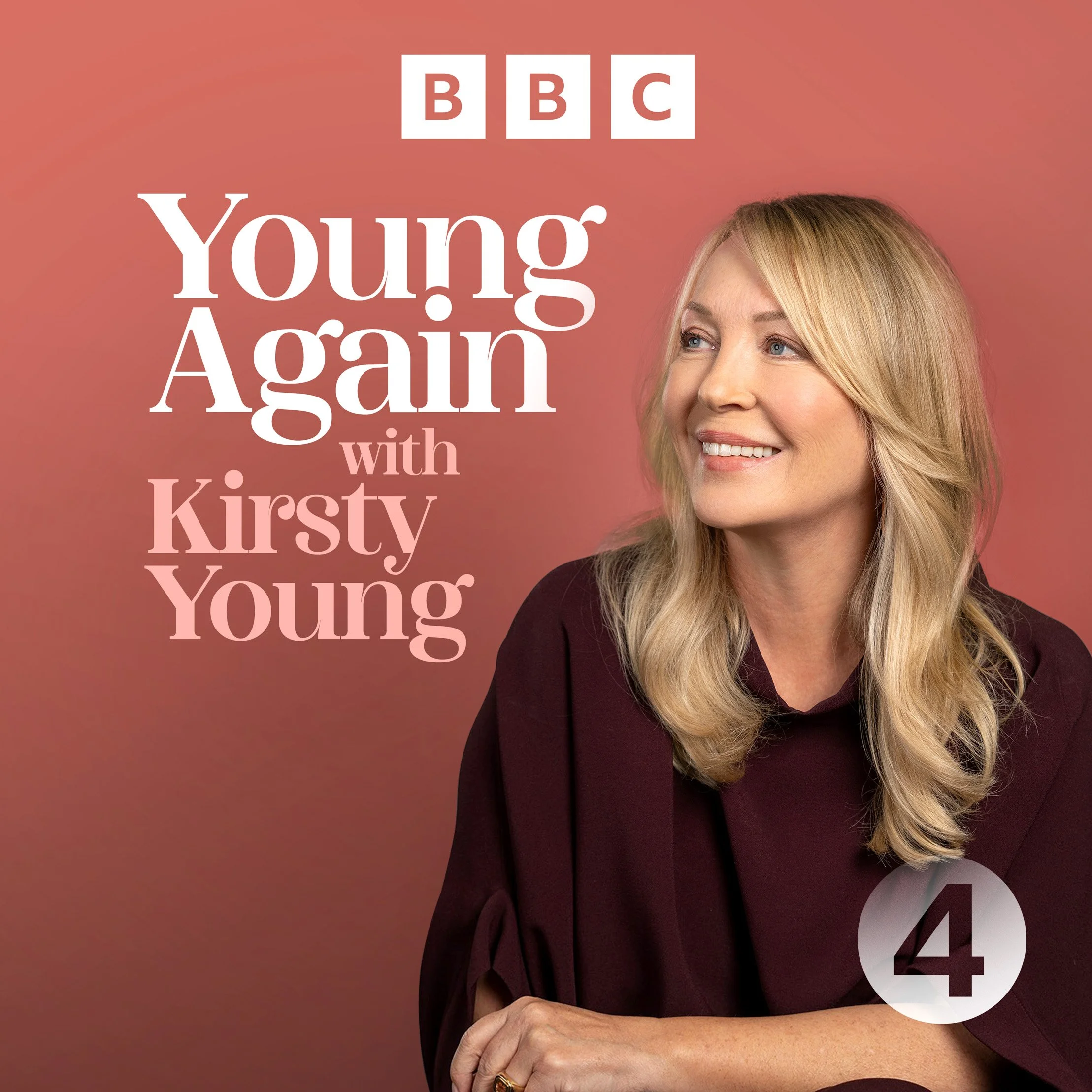 cover for the BBC podcast Young Again. presenter Kirsty Young smiles off camera, on a russet background, while wearing a soft, loose plum coloured top. dynamic entertainment portrait photography by Steve Bright London
