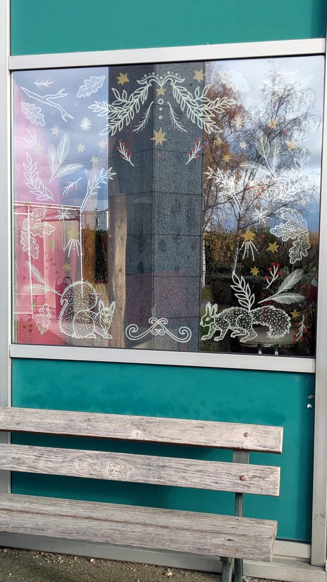 Vue d'ensemble de la façade de l'espace café décorée d'une peinture de Noël avec végétaux et écureuil pour le groupe Vygon à Ivry-le-Temple 