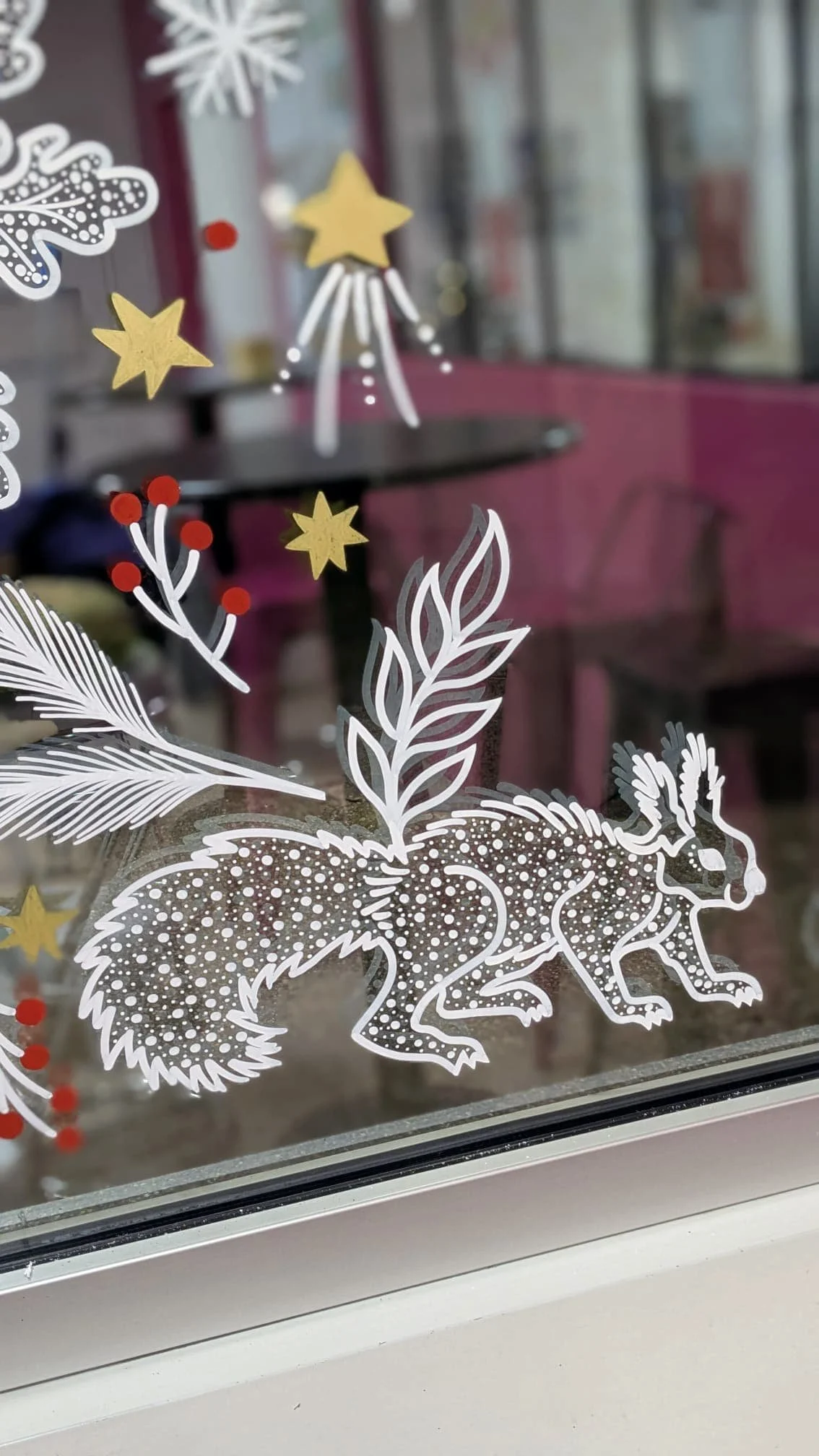 Peinture sur vitrine Noël - décoration entreprise - Espace café - porte - couronne de Noël - fenêtre motif végétaux et écureuil - détail - Groupe Vygon site Ivry-le-Temple