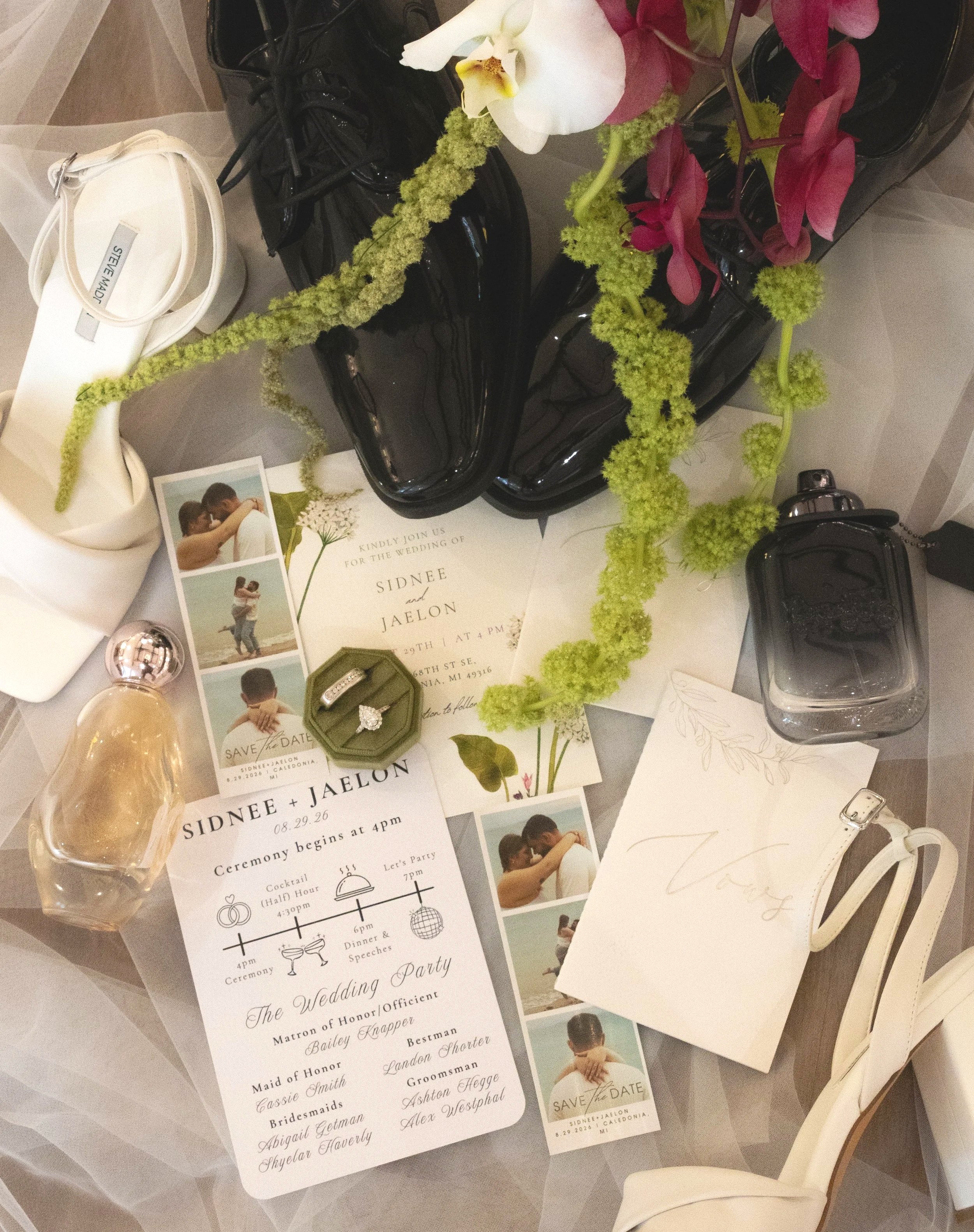Wedding invitation, photographs, flowers, and items related to a wedding celebration on a table.