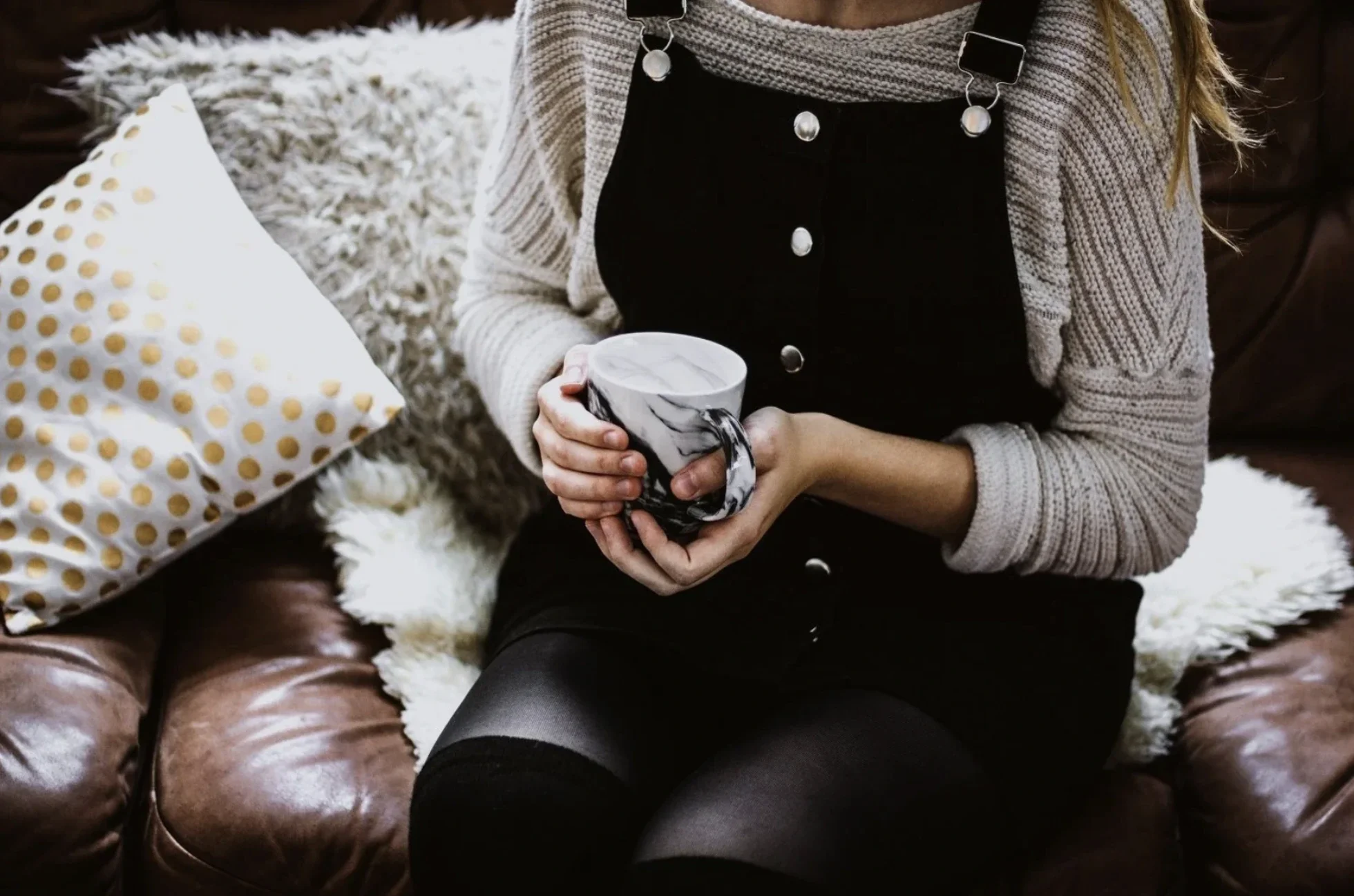 a woman drinking from a mug in an office