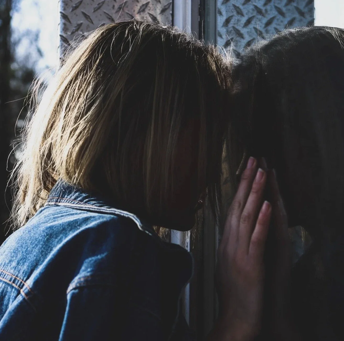 a person contemplating their identity and looking at their reflection