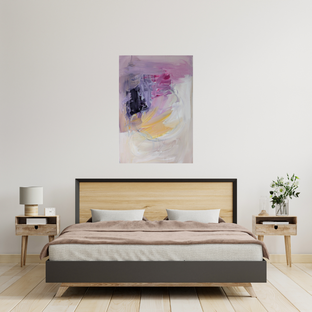 Modern bedroom with a bed that has a wooden headboard, beige bedding, and two white pillows. Two wooden nightstands with drawers, one with a lamp and clock, the other with a plant and glass candle holder. Abstract pink, purple, white, and yellow painting hanging above the bed.
