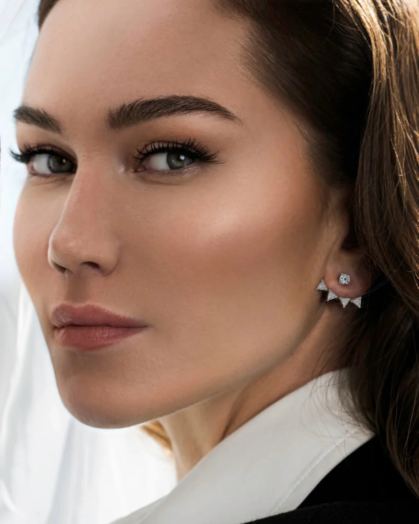 From the Ready-To-Wear Collection, these earrings by Laura Gallon feature trillion-cut diamonds that float below minimalist round diamond studs.

Crafted in 18 karat white gold with 1.33 carats of brilliant diamonds, they combine innovation and elega