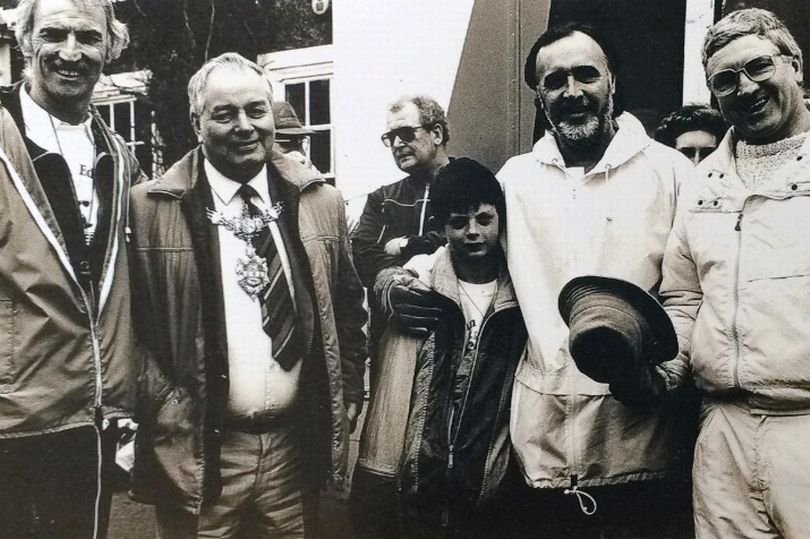 This photo was taken in 1988 on a charity walk in memory of the Munich Air Disaster of 1957 in which several Manchester United players were killed. It shows Billy Sutton second from the right with his arms around a schoolboy who did the walk with the