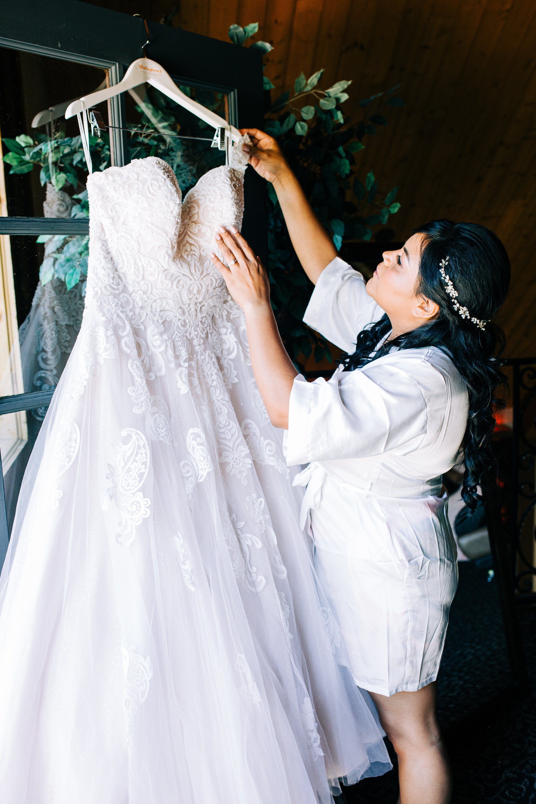 bride hanging her wedding dress.jpg