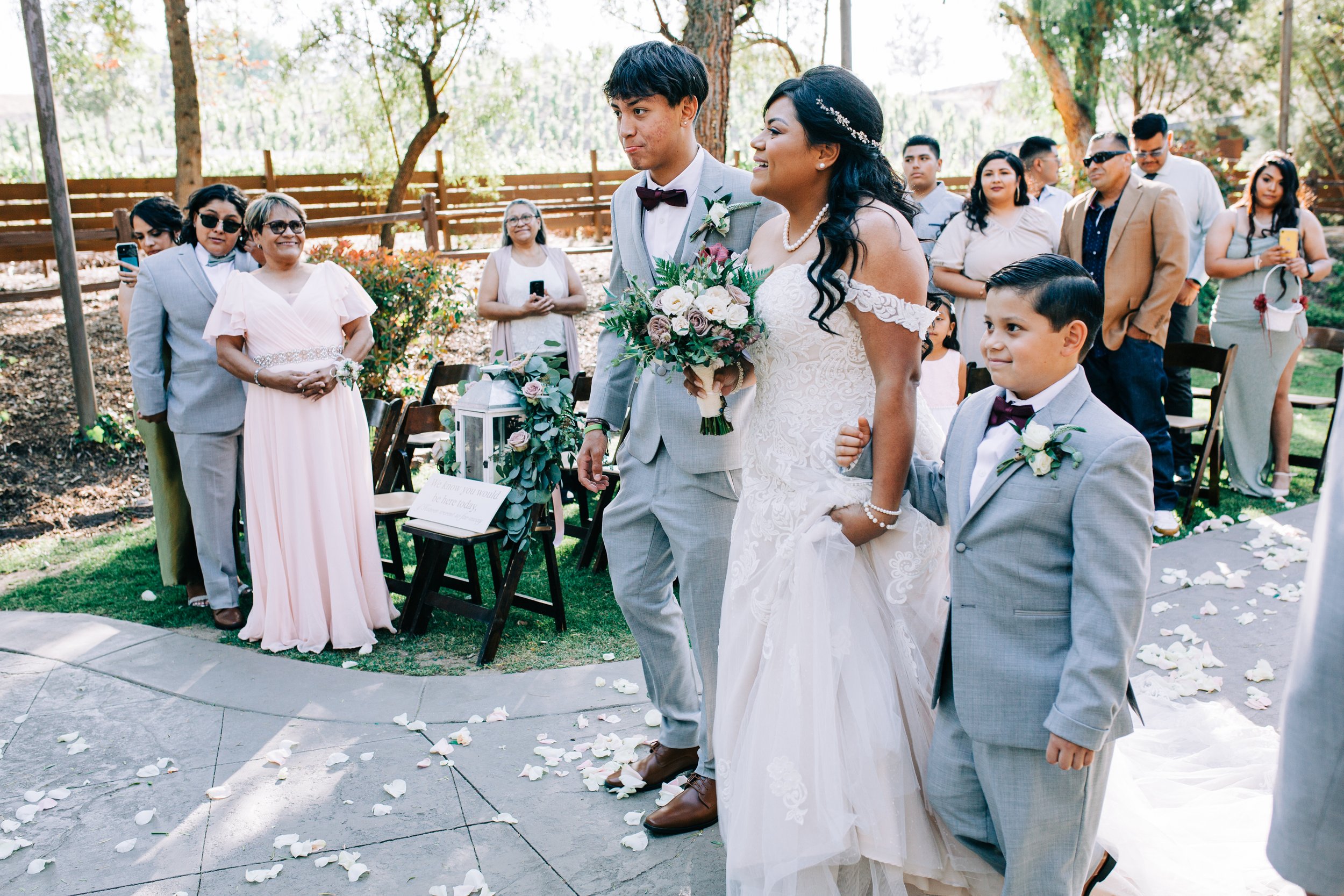 bride walking down the aisle with her sons.jpg