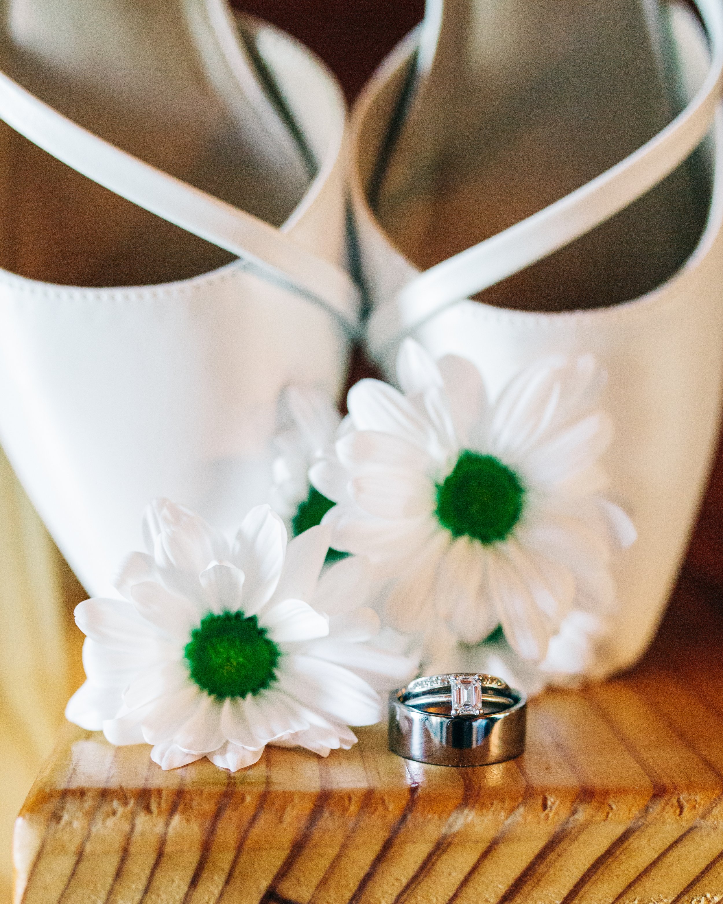 Wedding shoes with daisies and wedding rings.jpg